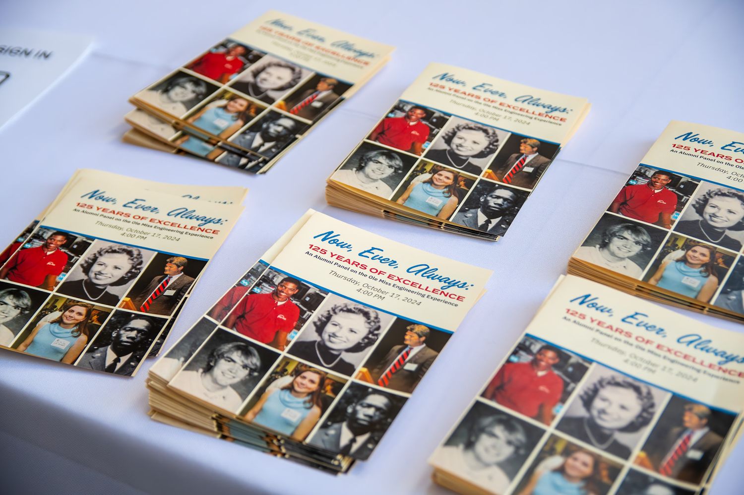 Wedding business cards and photo prints arranged in a line on a light blue background showing printed photography samples.