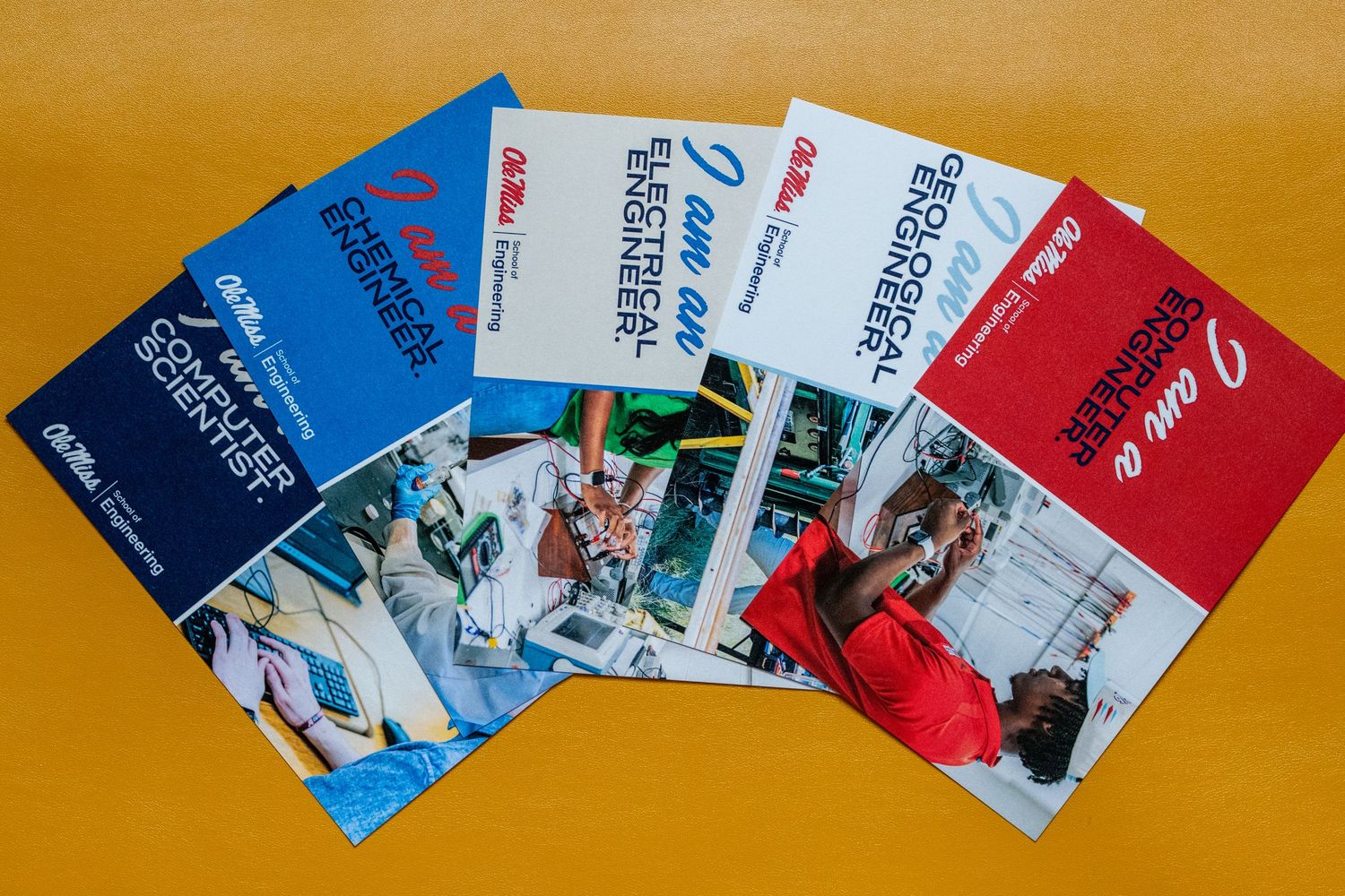 Five colorful educational booklets fanned out on a yellow background, featuring images of engineers and technical content.