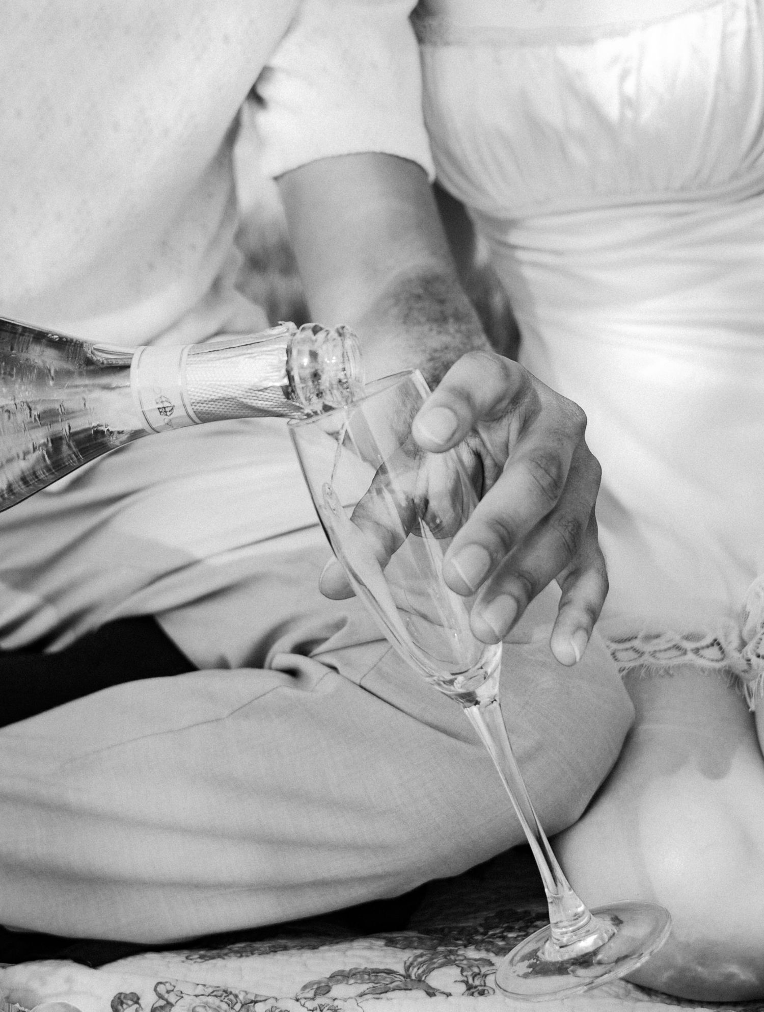 Hands delicately holding stemware glasses during an outdoor social gathering. Photo shot by Mikiah Nicole Dixon