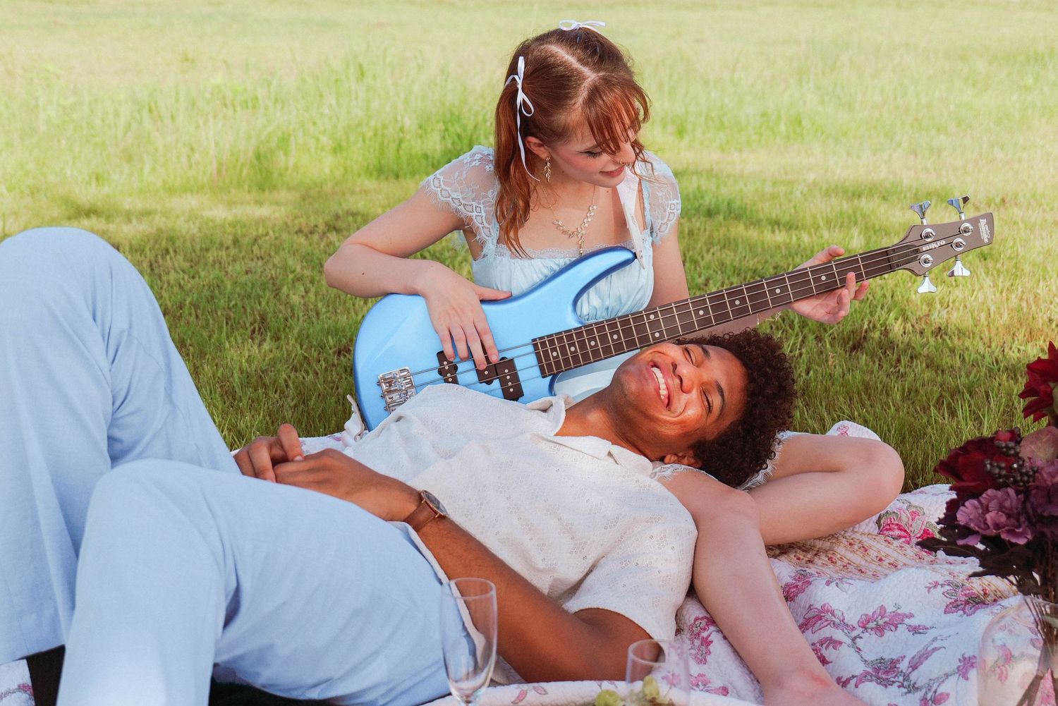 Couple relaxing on blanket outdoors with acoustic guitar on sunny day. Photo shot by Mikiah Nicole Dixon
