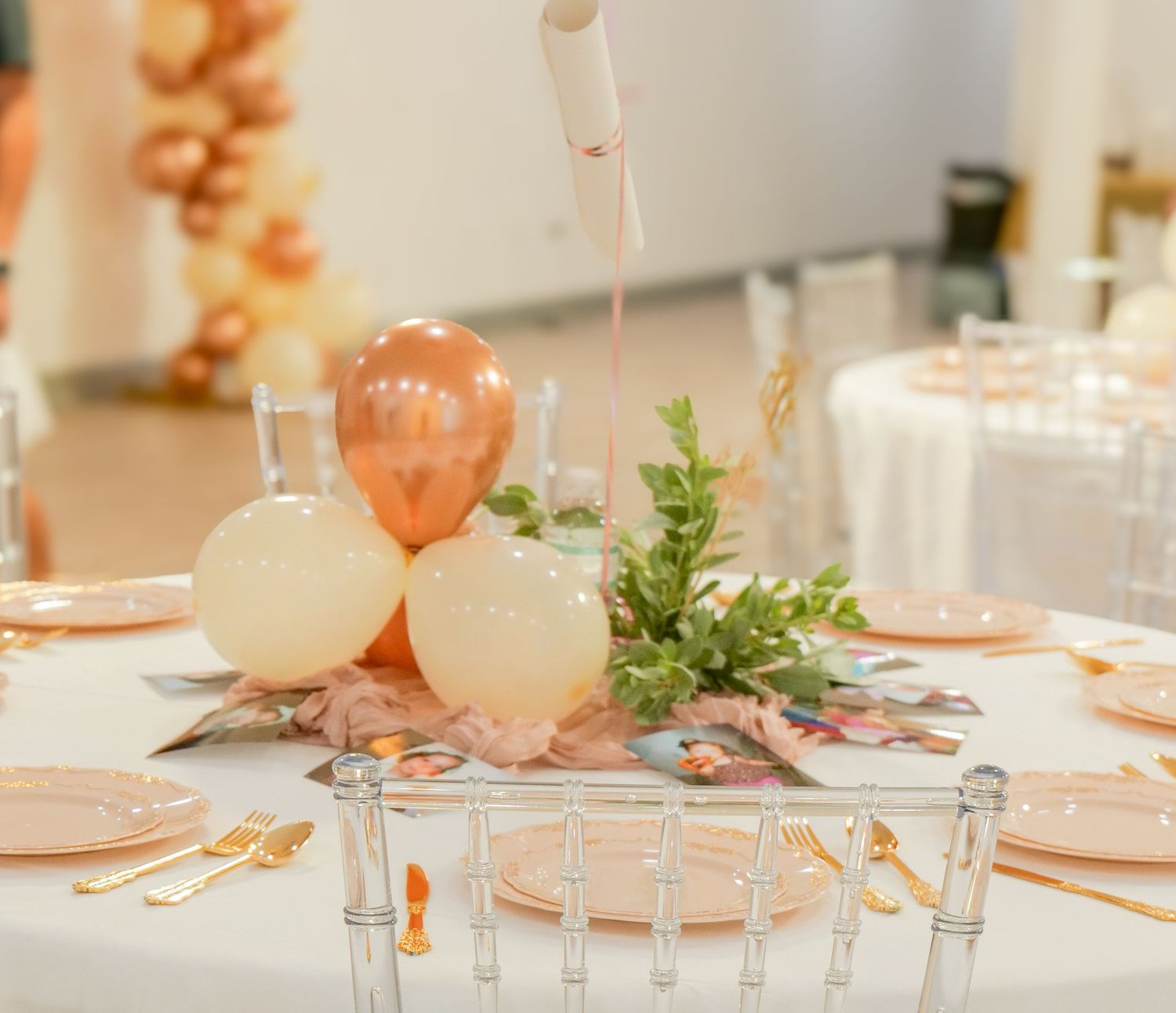 Elegant party table setting with rose gold and cream balloons and greenery accents. Photo shot by Mikiah Nicole Dixon