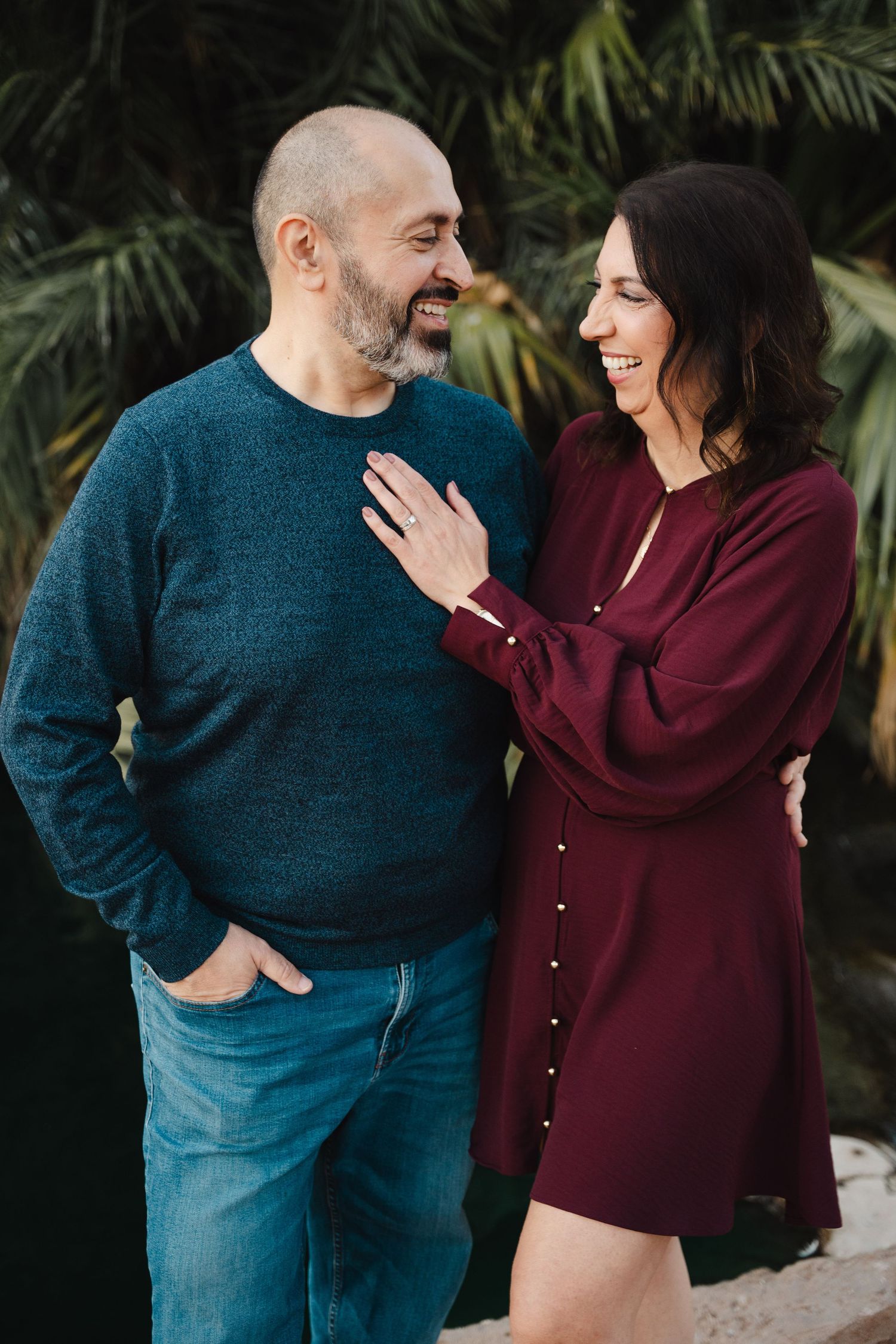 Couple laughing together during a relaxed outdoor portrait session in Des Moines, Iowa.