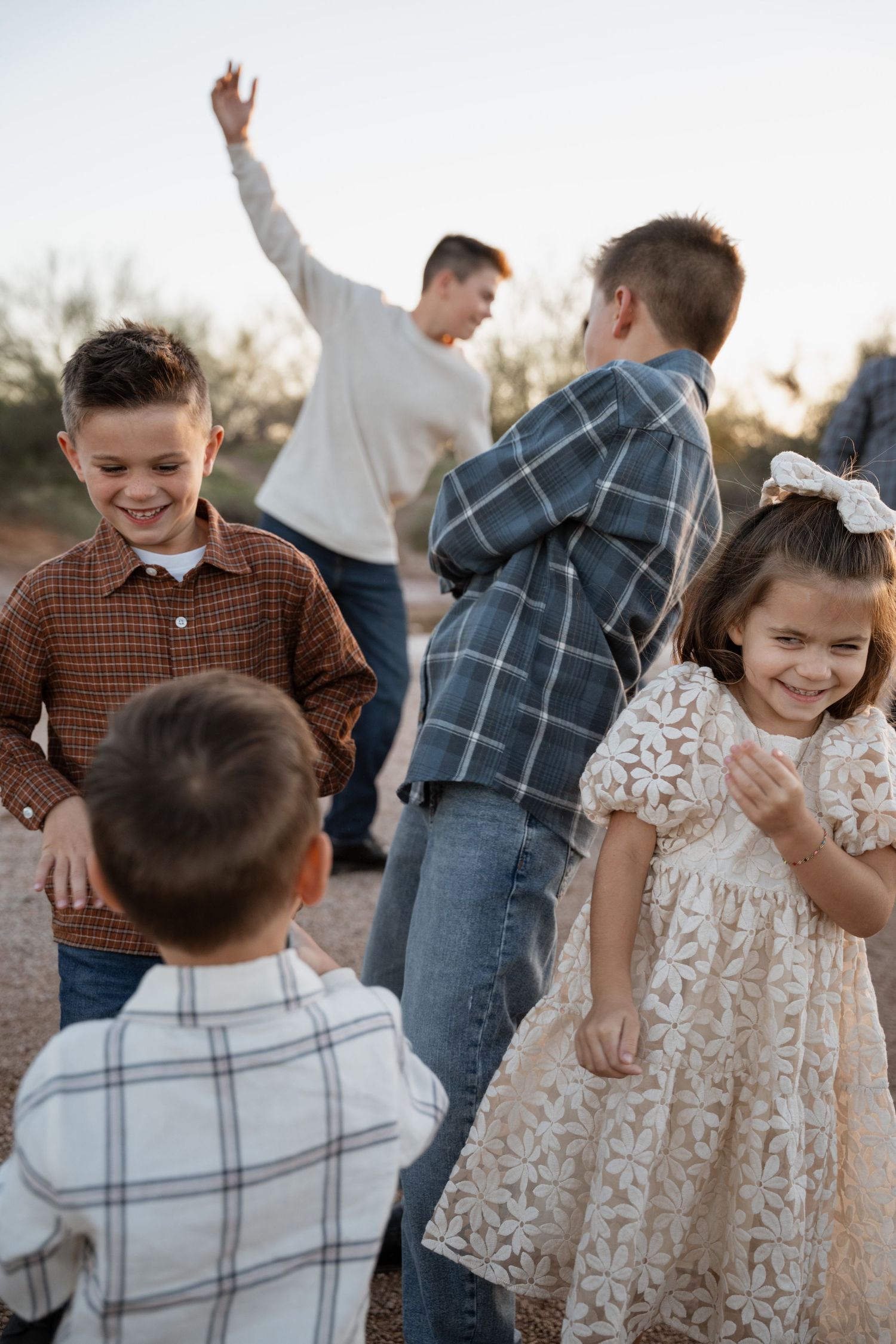 Des Moines Iowa family photographer – relaxed outdoor portrait of kids playing with one another.