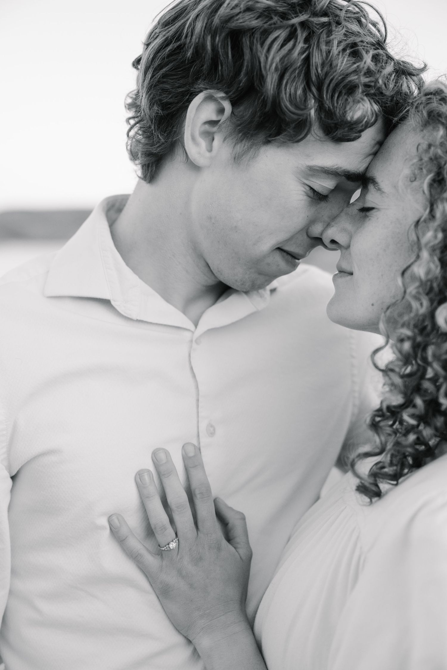 Authentic Des Moines engagement photography – classic black and white close-up of couple with foreheads touching, romantic and timeless.