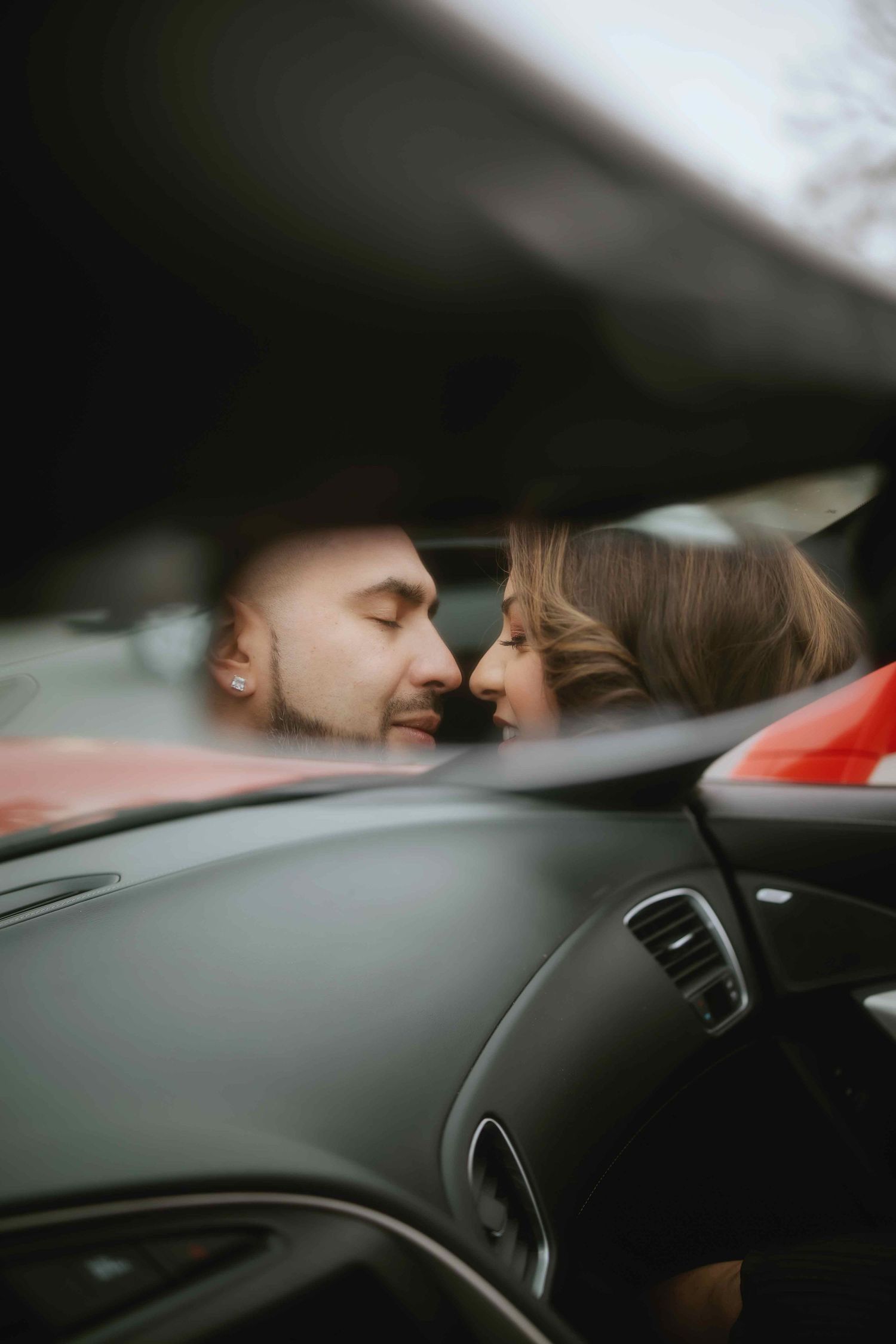 Intimate car interior photo of couple sharing a romantic moment through the windshield.
Couple shoot