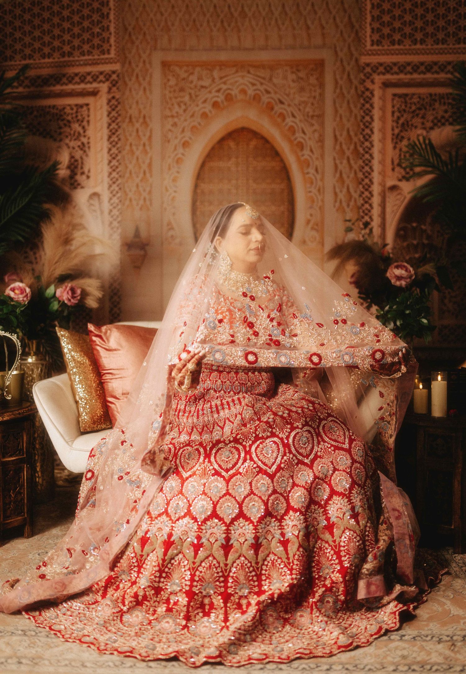 A traditional South Asian bridal portrait with ornate red lehenga and delicate veil details.
Bride portrait photography