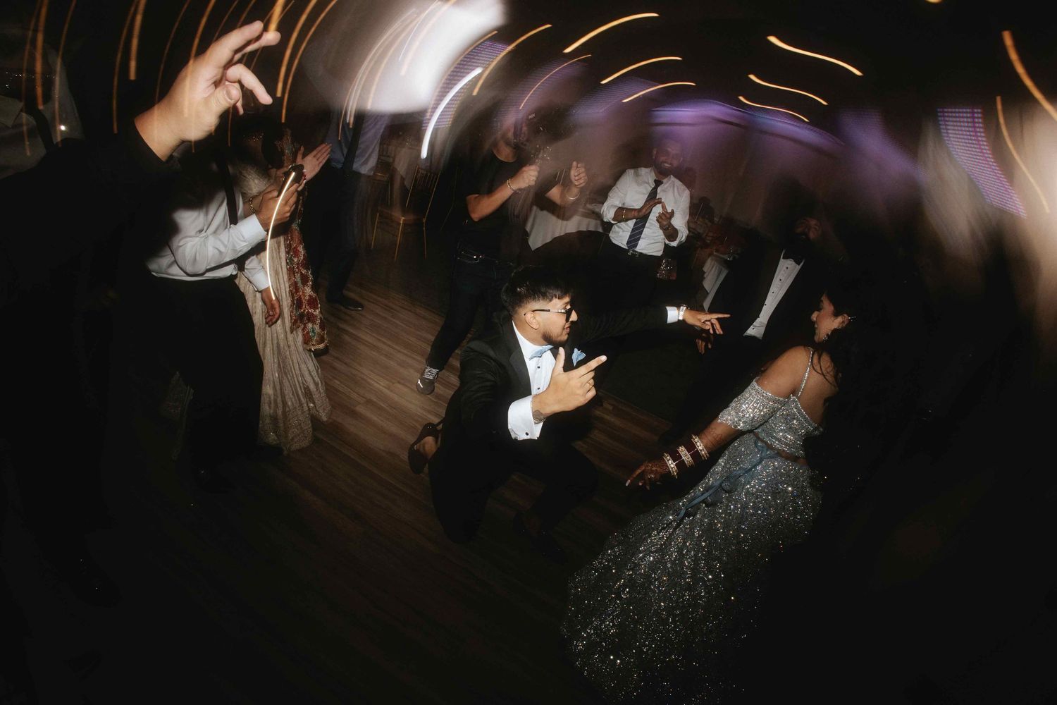 Wedding reception dance floor moments captured with creative light trails and motion.
Reception photography