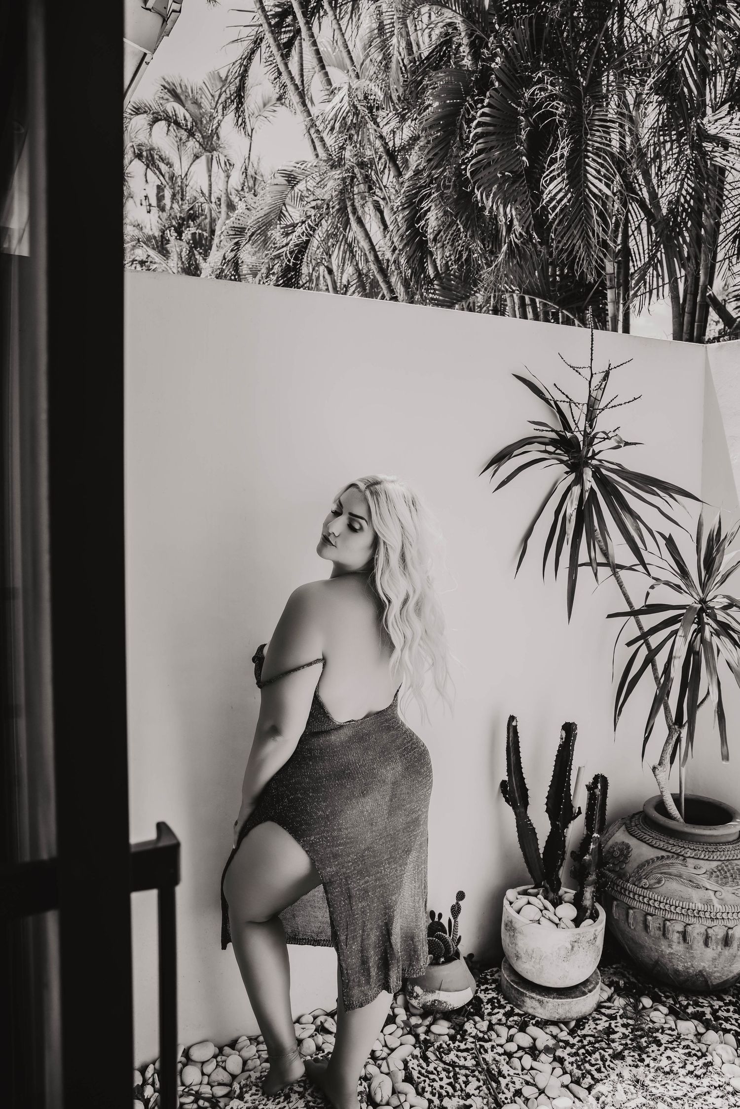 black-and-white images of a woman wearing a  dress looking away in a outdoor Bradenton Modern boudoir studio