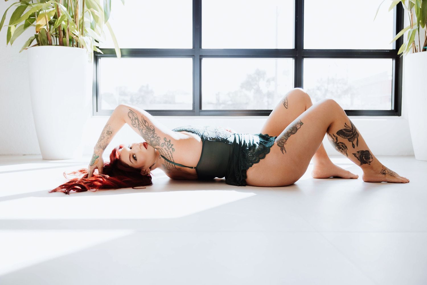 Women reclining in a green lingerie durning a light-filled Sarasota modern session