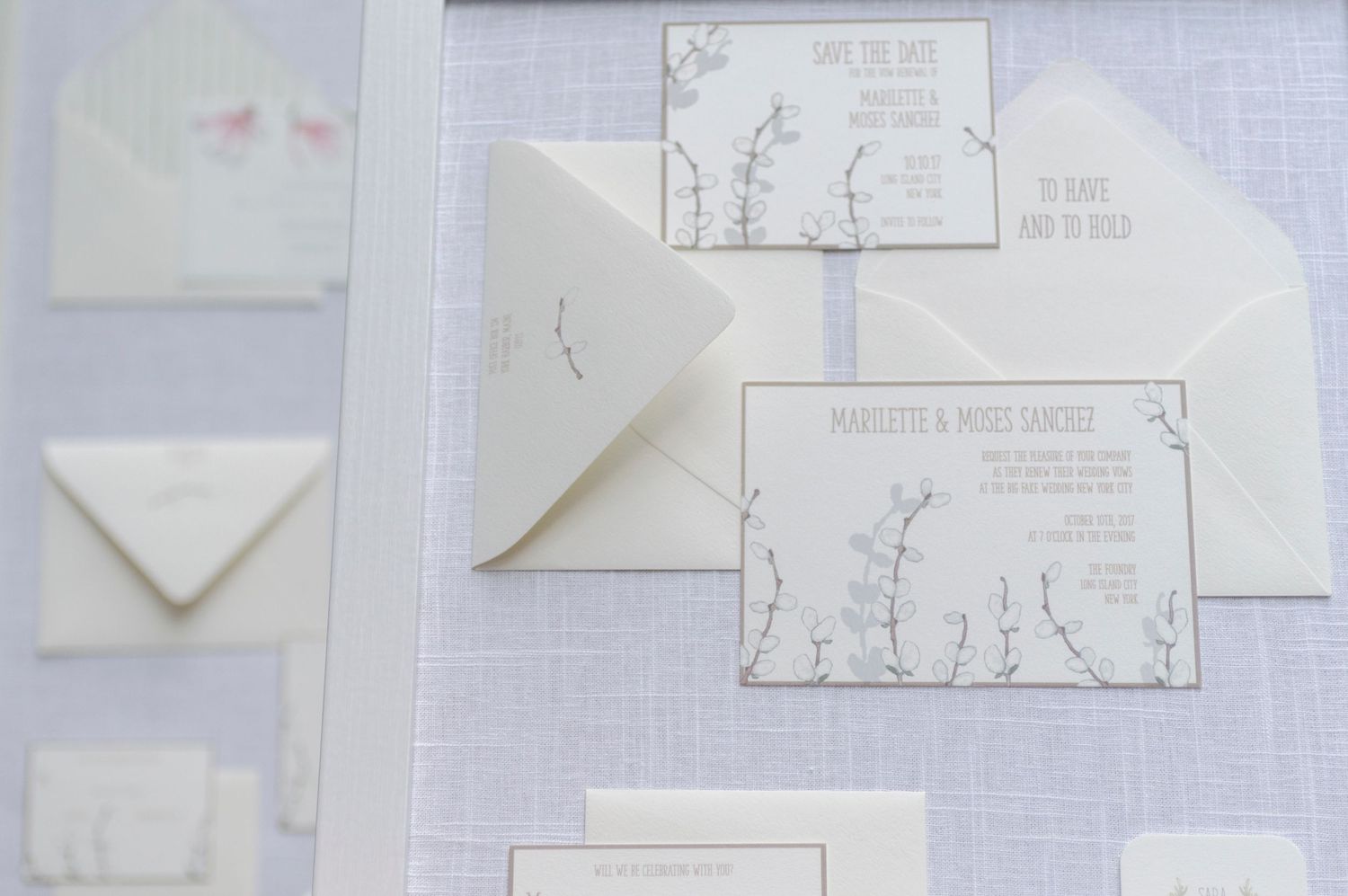 Flat lay of a lavender-themed wedding invitation suite with envelopes and RSVP cards.