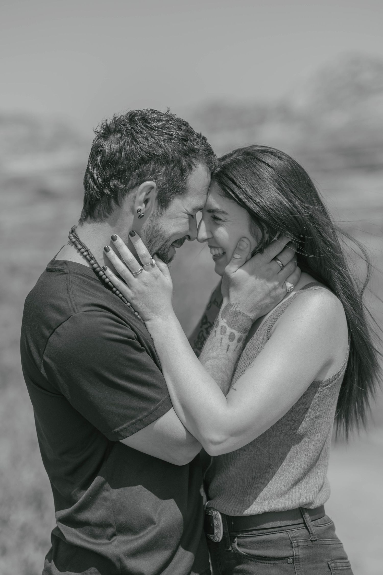 Couple sharing an intimate moment, holding each others faces, during a couples session.