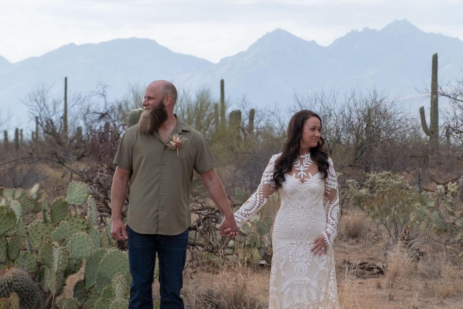Towering mountains in the background of a couple looking dreamy during their elopement.
