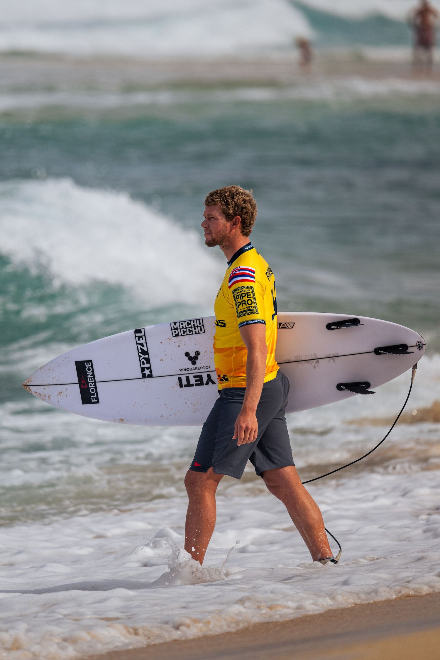 John John Florence heading out to compete in the 2025 Pipe Pro surf event at Pipeline beach on the North Shore of Oahu, Hawaii.