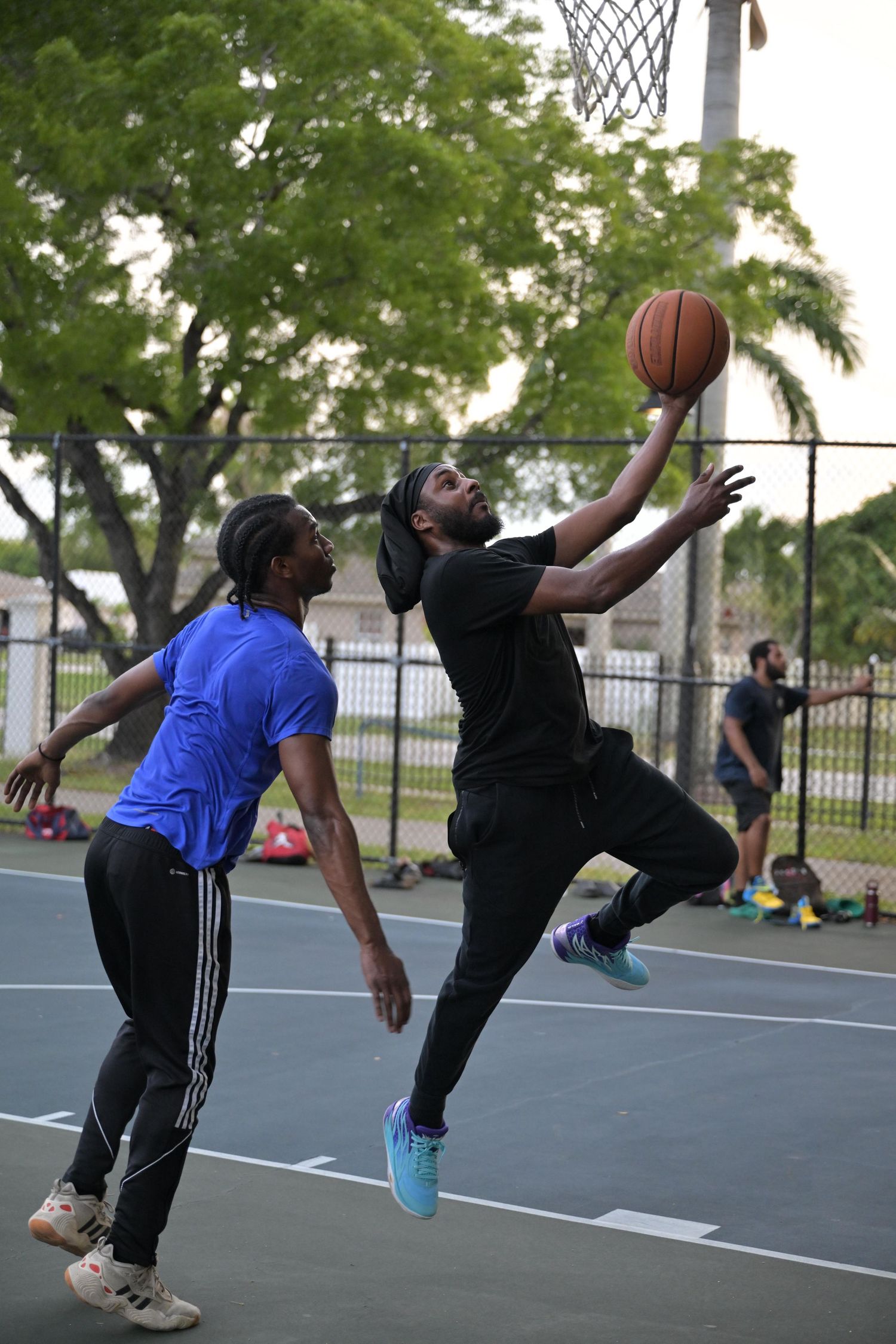 Basketball player making a layup in Lauderhill park — fast-paced action sports session.