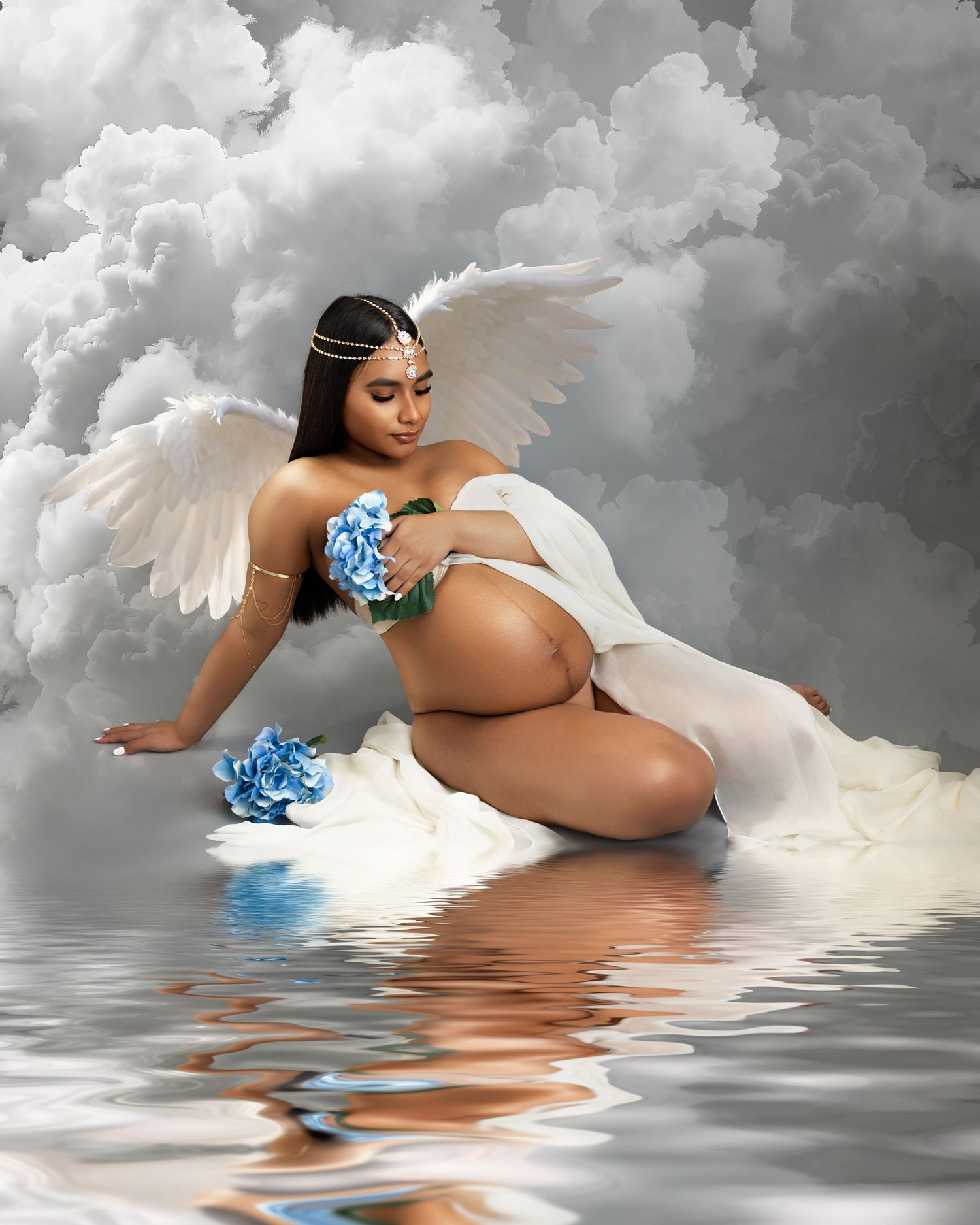 Artistic photo series showing an ethereal angel figure with white wings floating on reflective water with blue flowers.