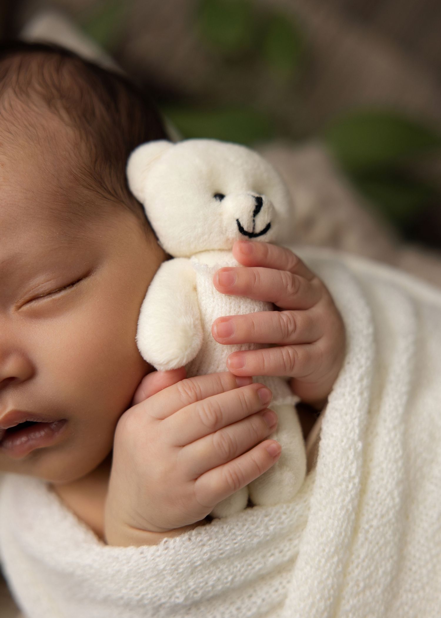 Multiple stages of a sleeping baby peaceful napping while cuddled with a soft white plush toy.