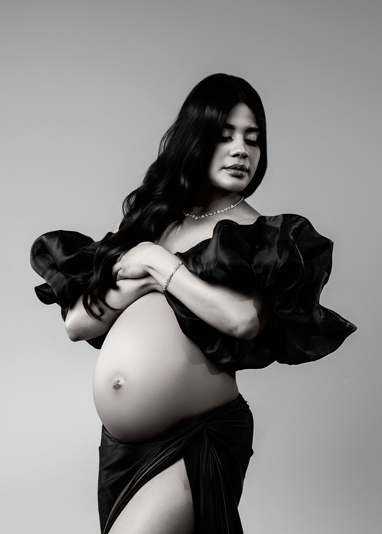 Black and white artistic portrait series showing dramatic poses against a simple studio backdrop.
