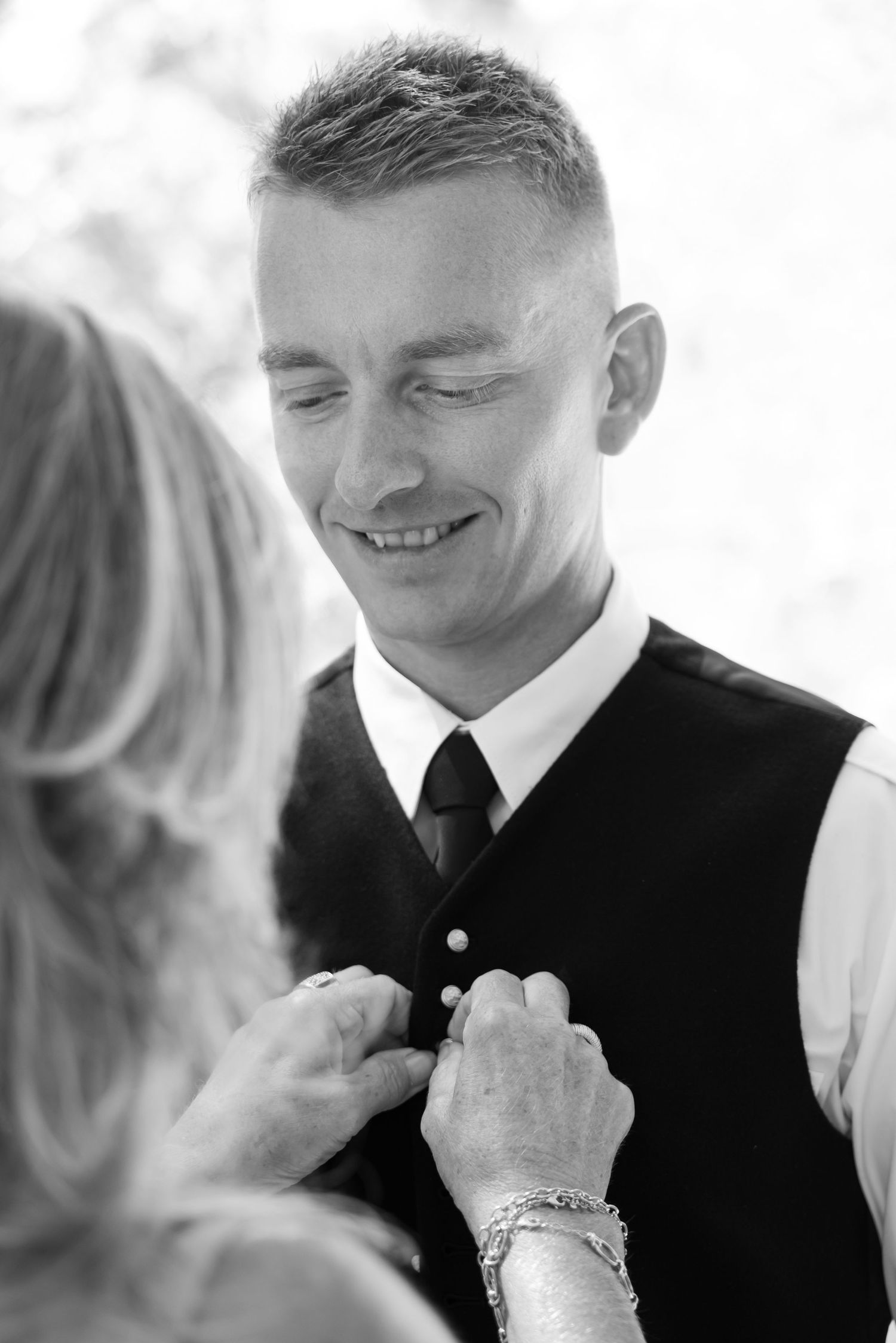 Close up portrait showing joyful expressions and warm smiles during a wedding ceremony.