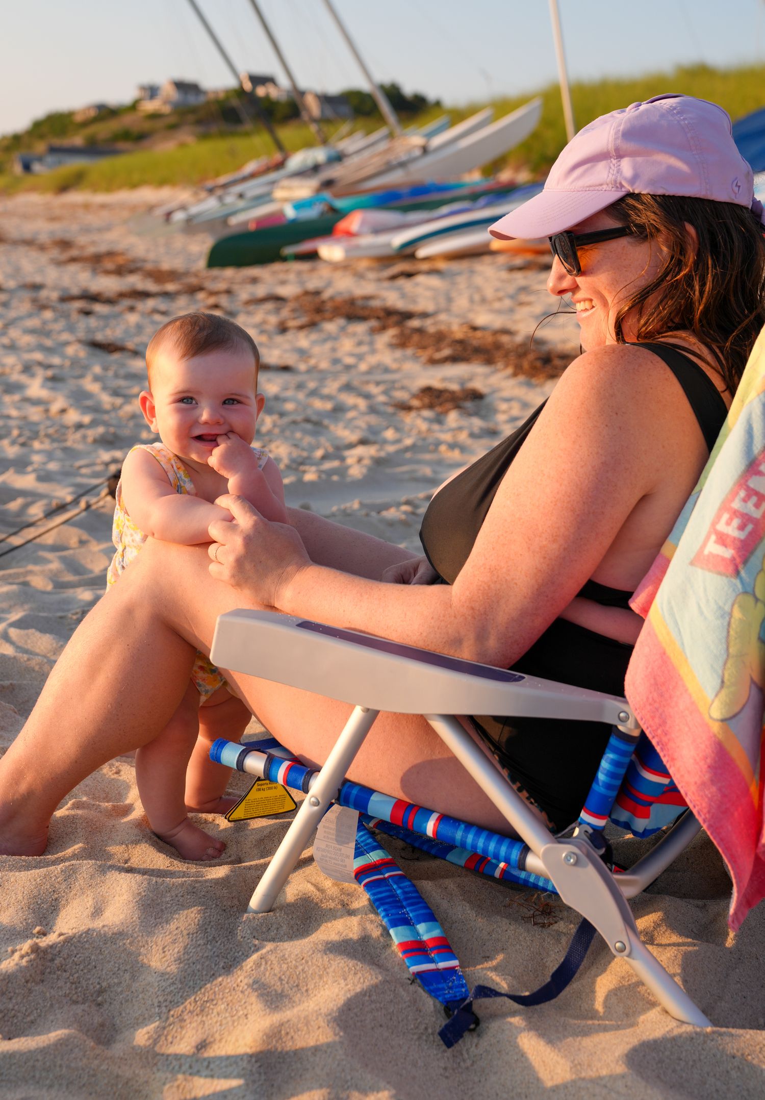A series of beach photos showing someone relaxing on sand with colorful beach gear and toys during sunset.