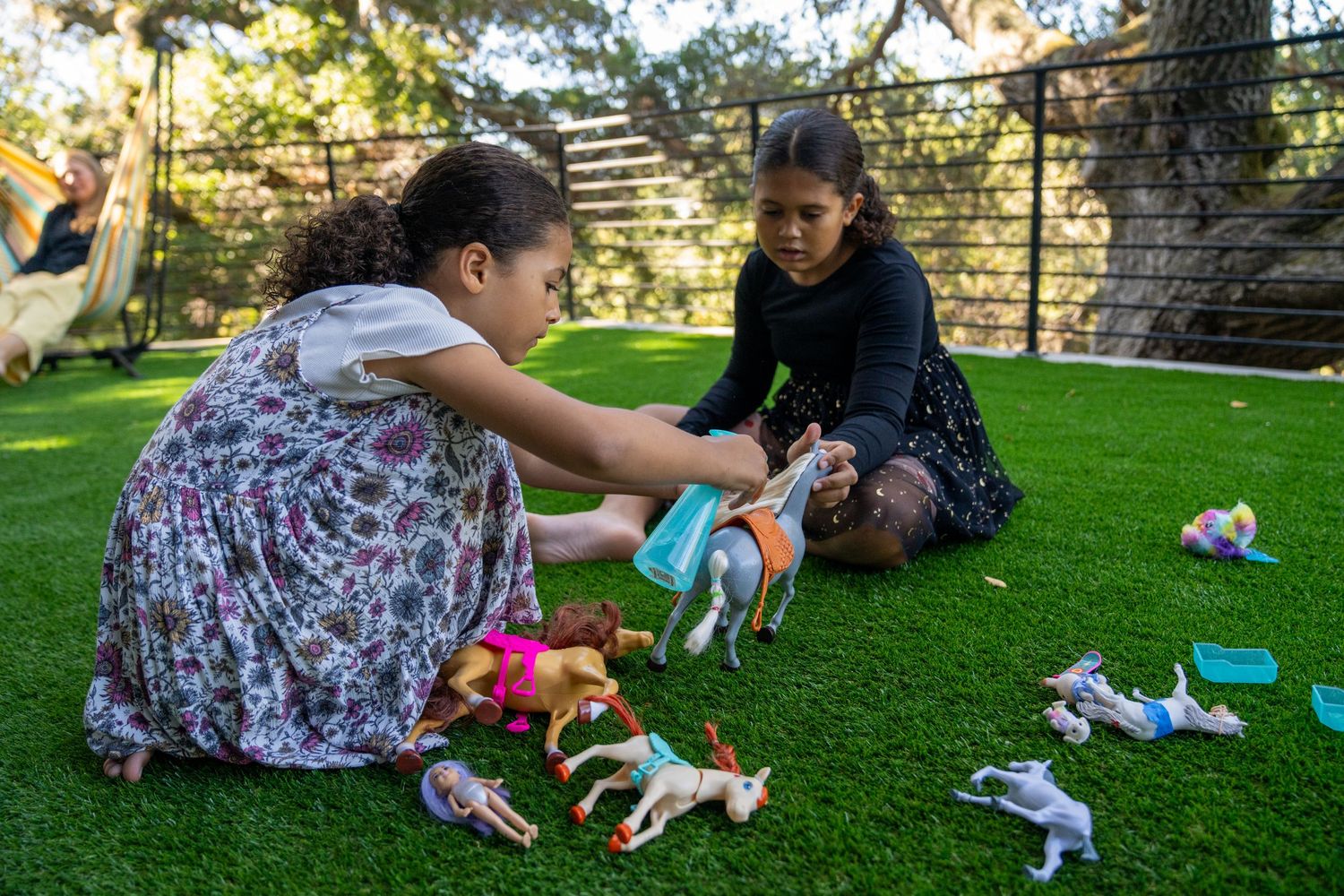 A sequence of photos shows someone playing with a small white puppy on green grass in a backyard setting.