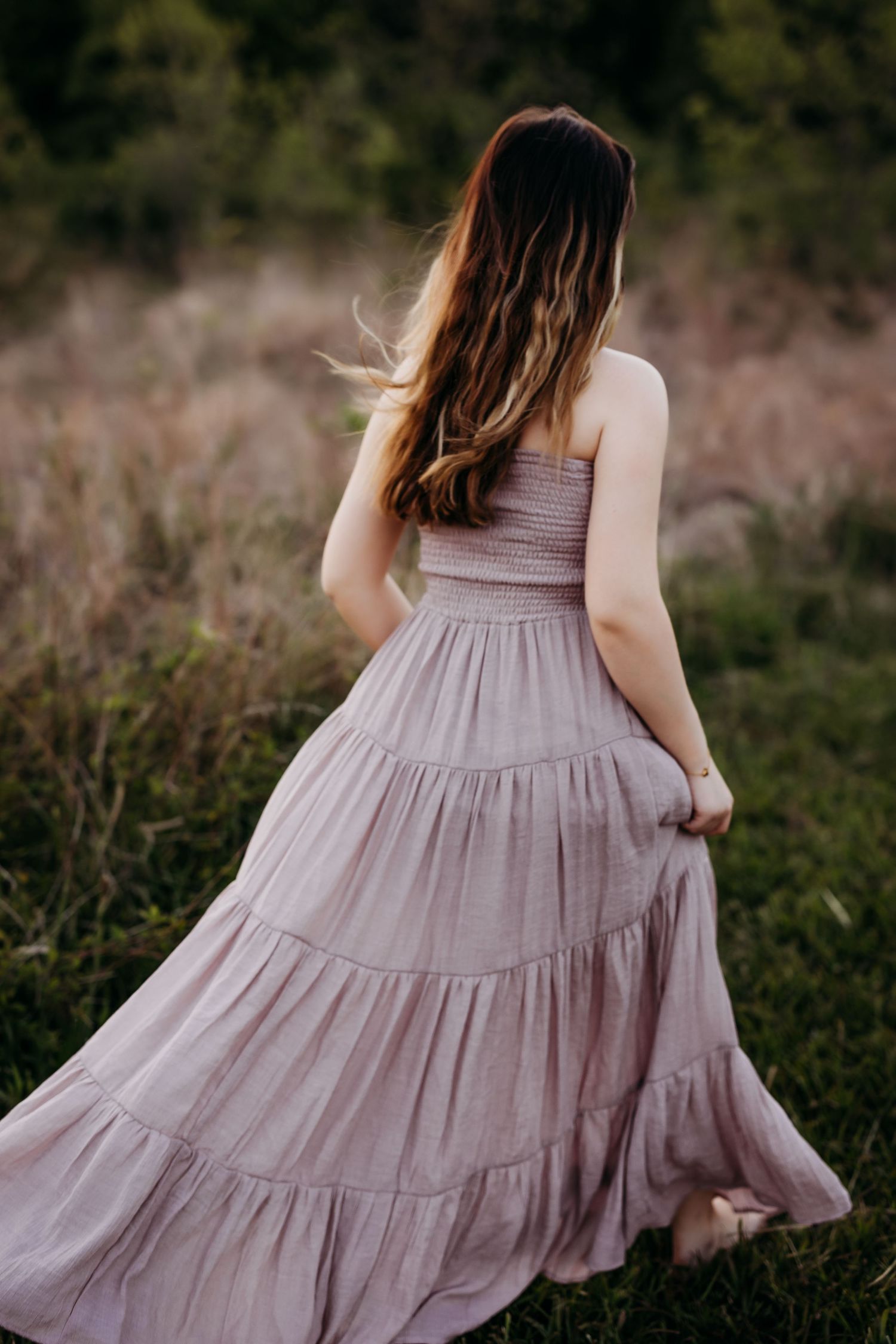 high school senior girl walking away with dress flowing behind her