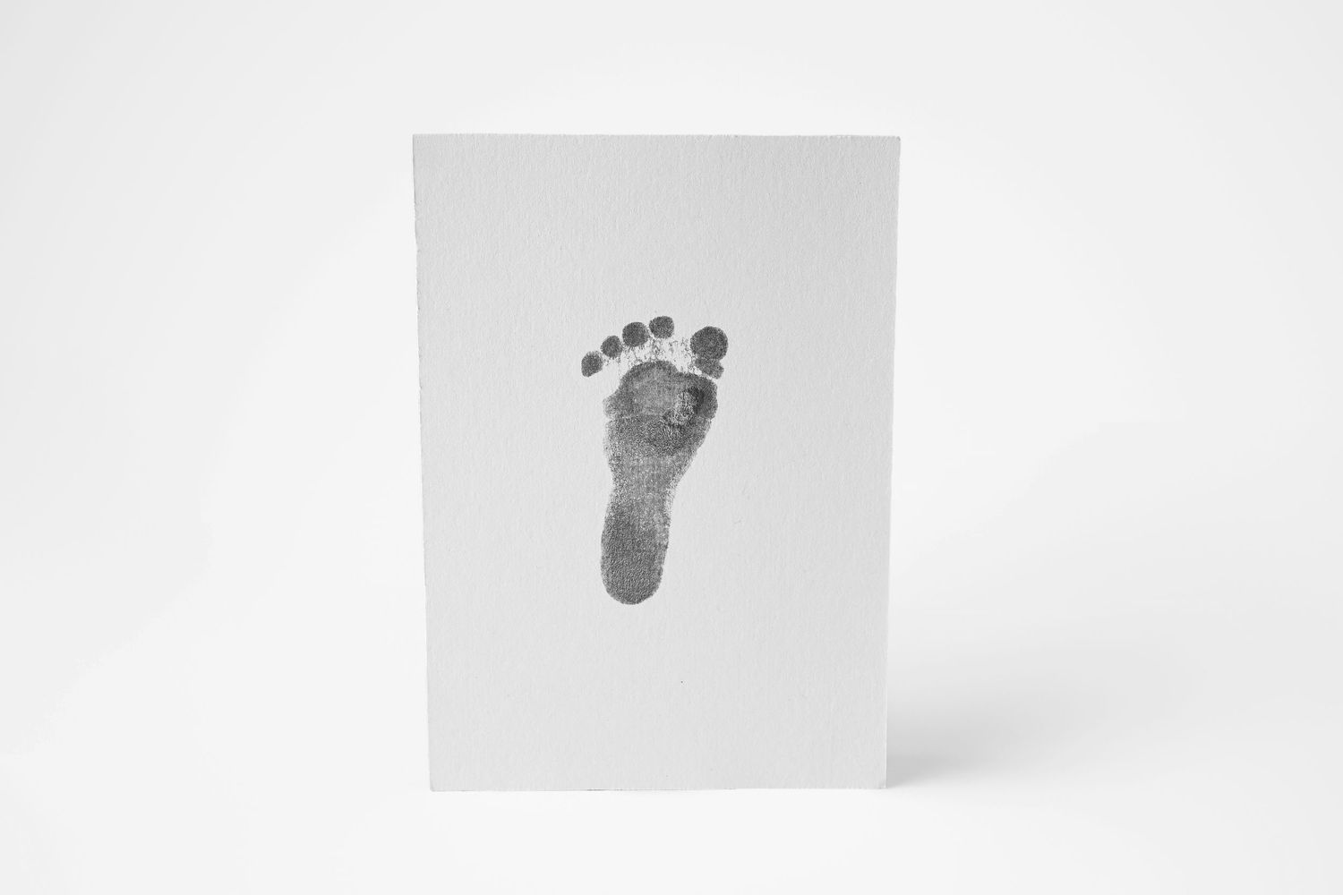 Black and White image of a newborn baby's footprint. A luxurious handmade keepsake by Olivia Grace Photography in Phoenix Arizona
