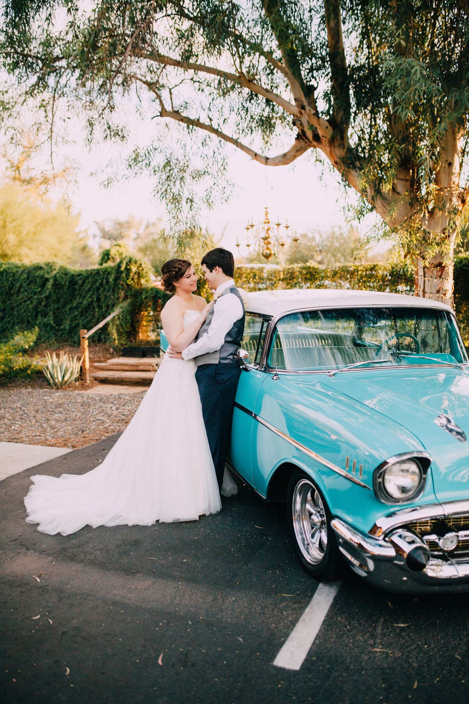 Wedding photo of couple in Gilbert Arizona with a 55 Chevy