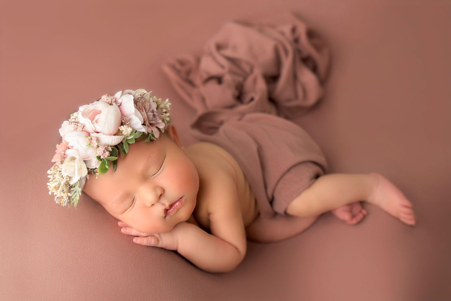 Newborn baby girl laying on pink blanket in Ahwatukee photo studio.