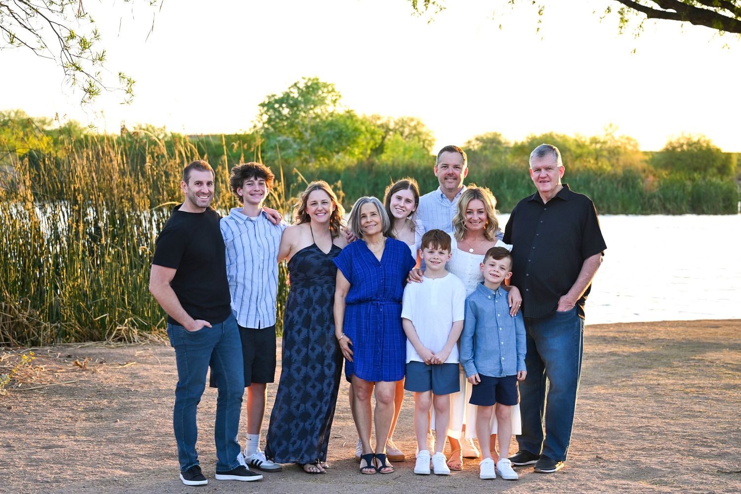 Large extended family stands posed together on waters edge in Chandler Arizona