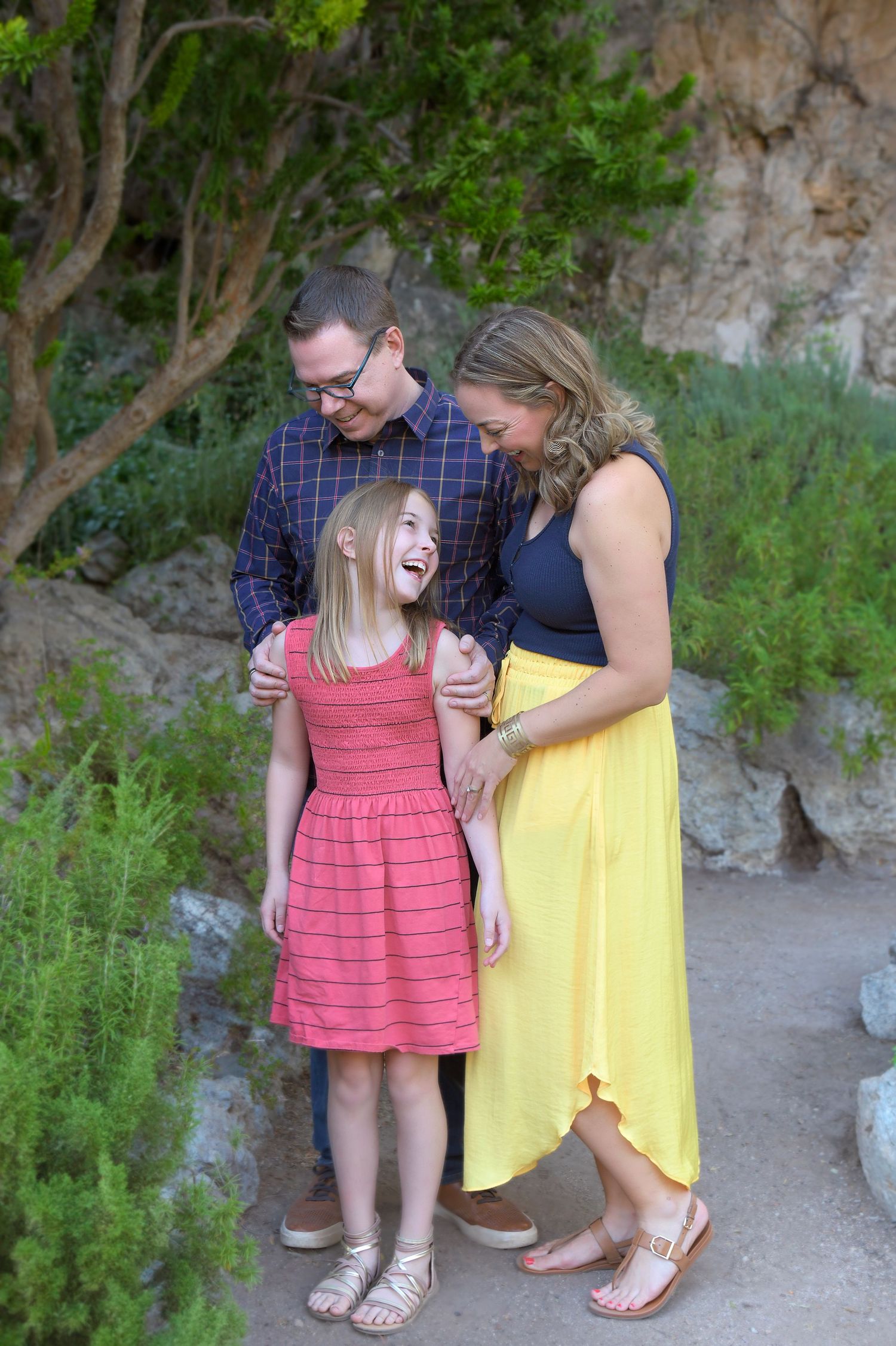 Small family walks through a park in Northern Arizona smiling at the beautiful scenery