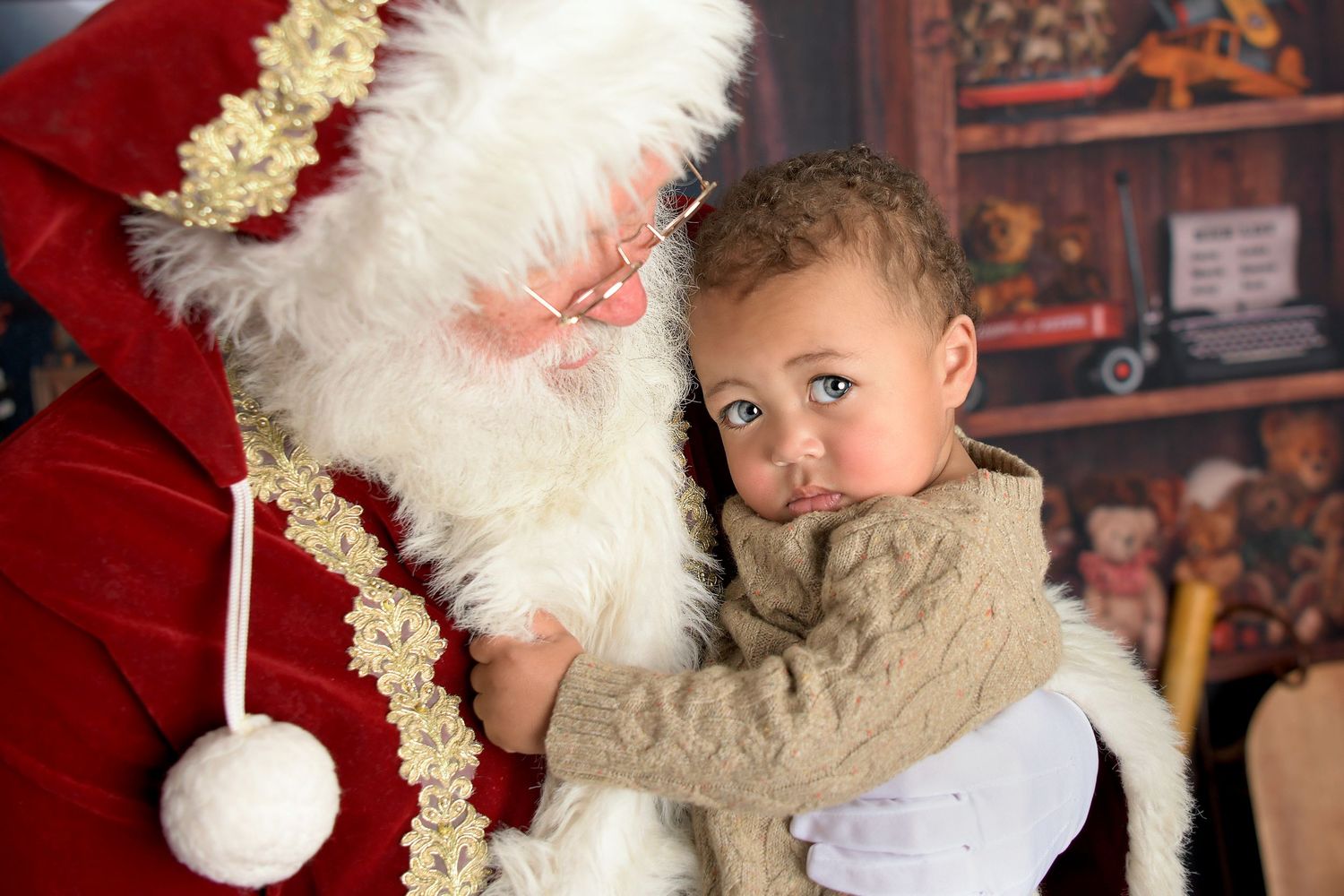 Santa Claus Workshop North Pole cuddling toddlers in Phoenix Arizona Holiday Christmas Mini Session