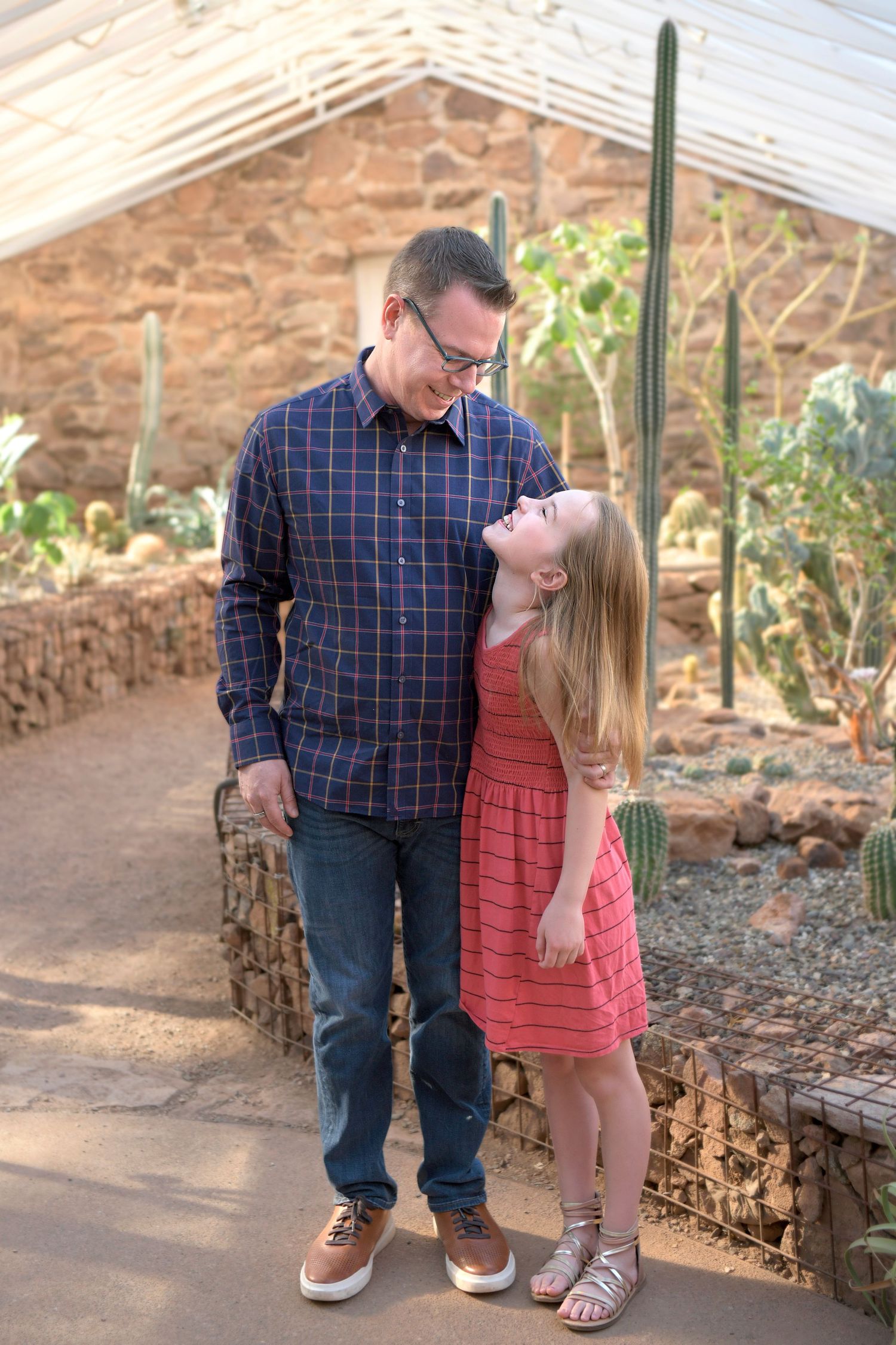 Father Daughter stand in desert greenhouse in Northern Arizona