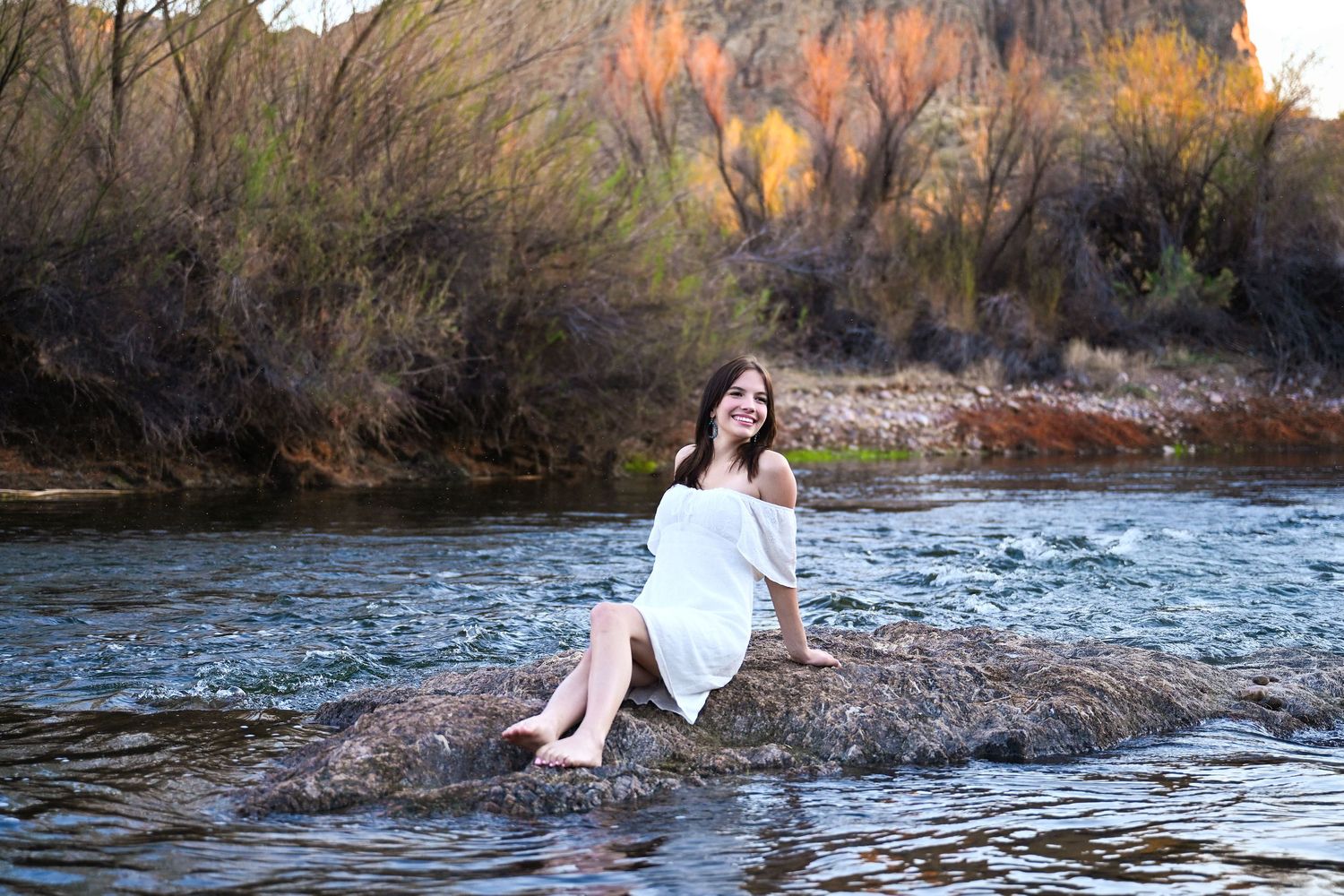 Senior Graduation session at Salt River Arizona girl on rock in the middle of desert water