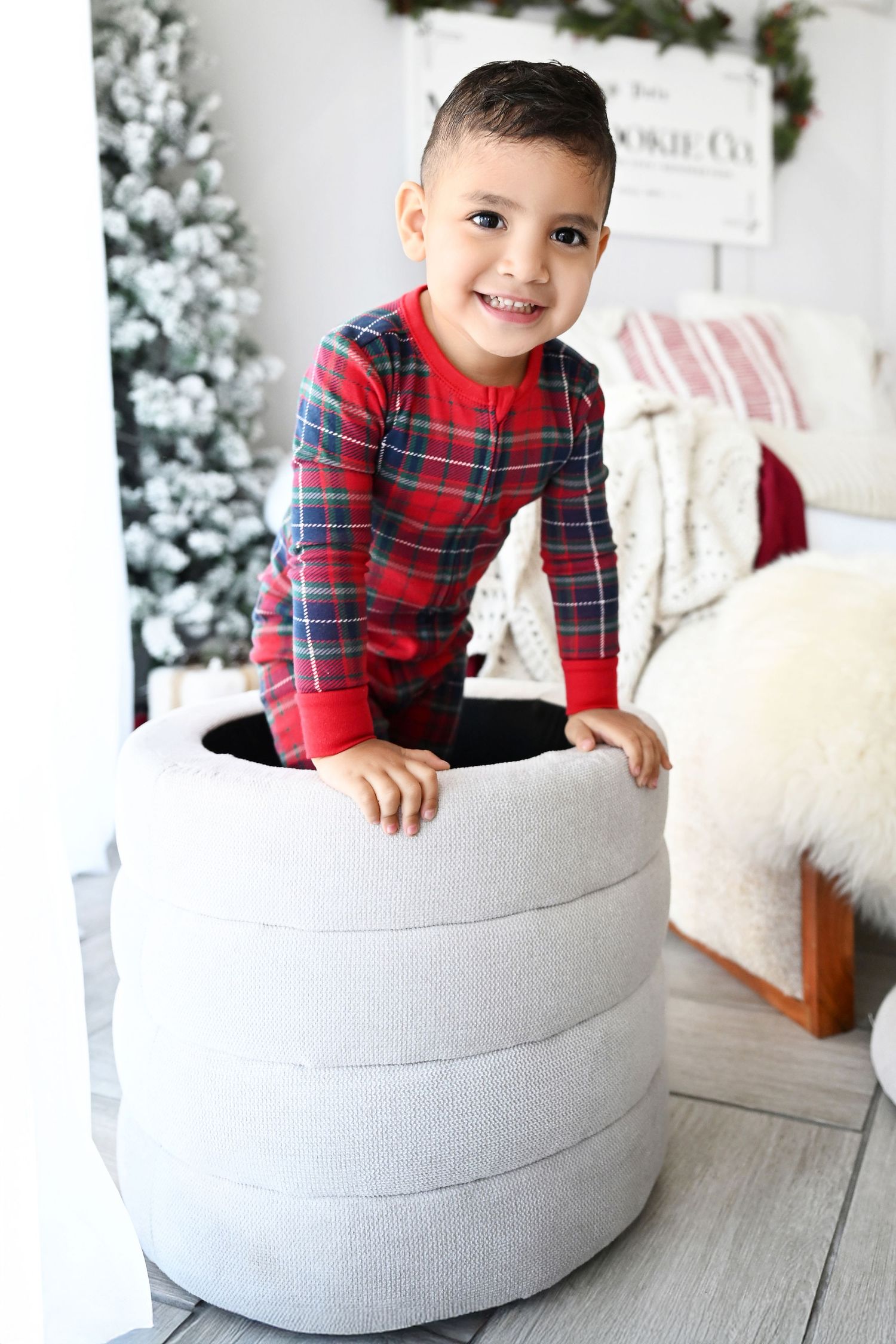 Portrait of laughing child smiling with Christmas tree in white Ahwatukee Arizona Photoshoot Olivia Grace photography
