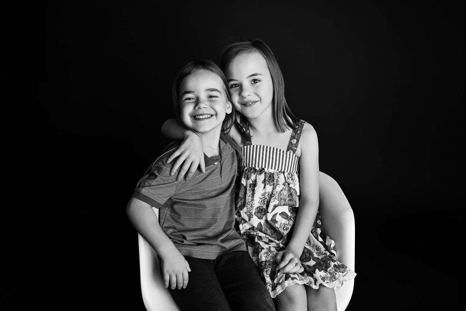 Black and White photo of siblings cuddling in Arizona Photography Portrait Studio