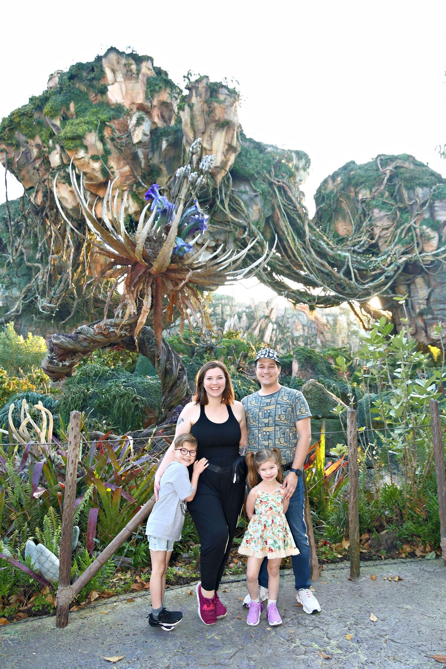 Family of four in Disney world EPCOT smiling at the camera