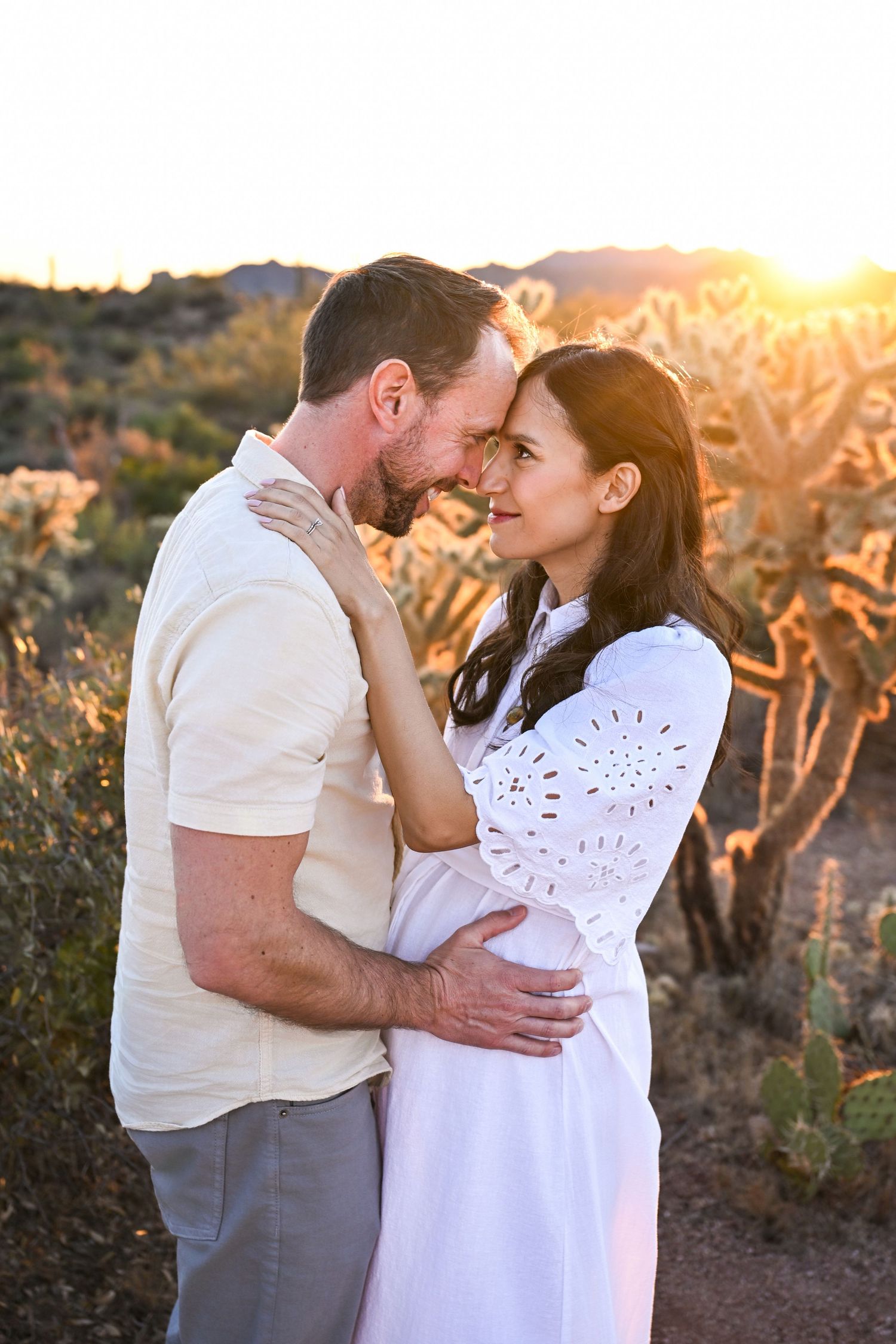 Expectant parents gazing at each other with joy.