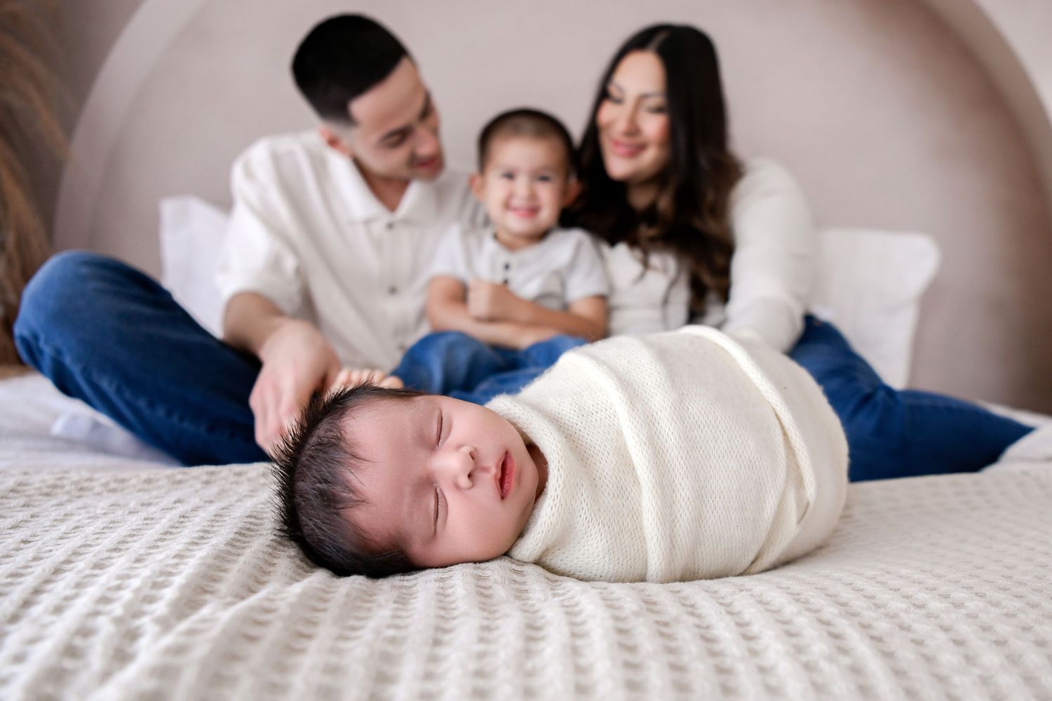 Candid image of newborn and family with toddler smiling in natural light Phoenix Arizona Studio