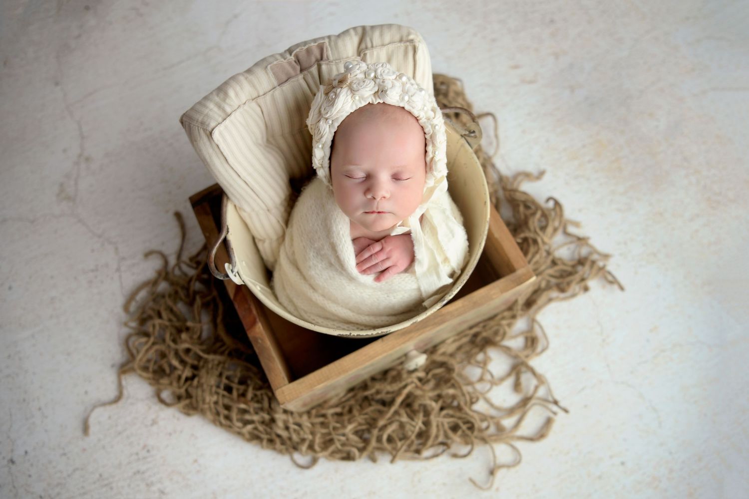 Newborn baby girl in a bucket in Tempe AZ newborn photography studio