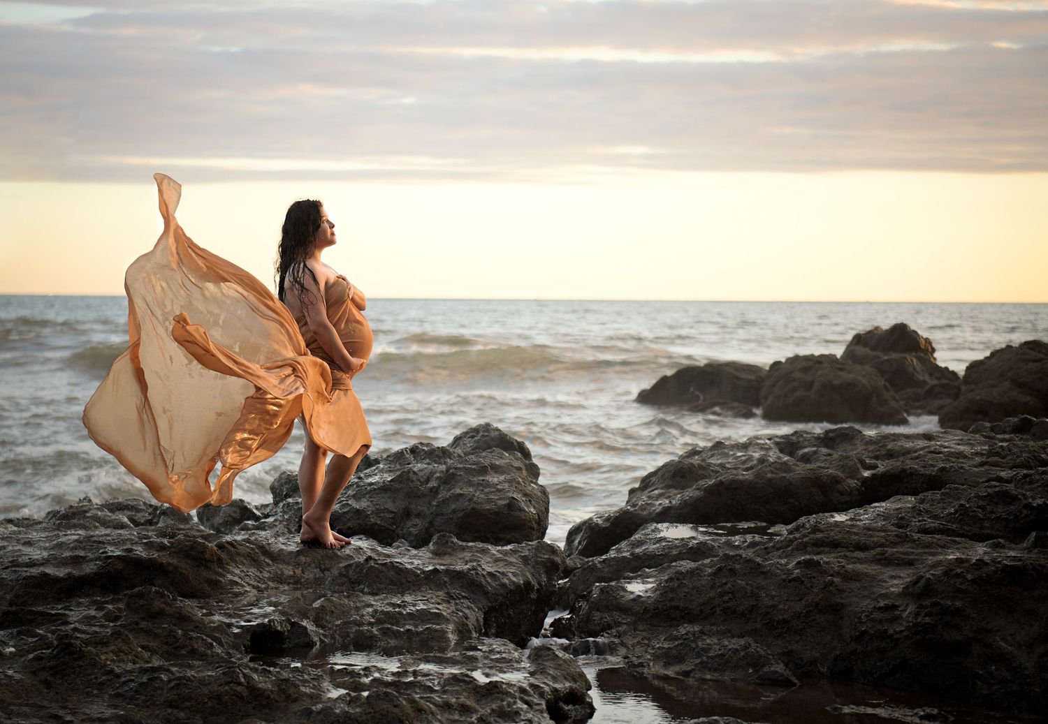 Celebrate maternity with a playful beach scene with friends.