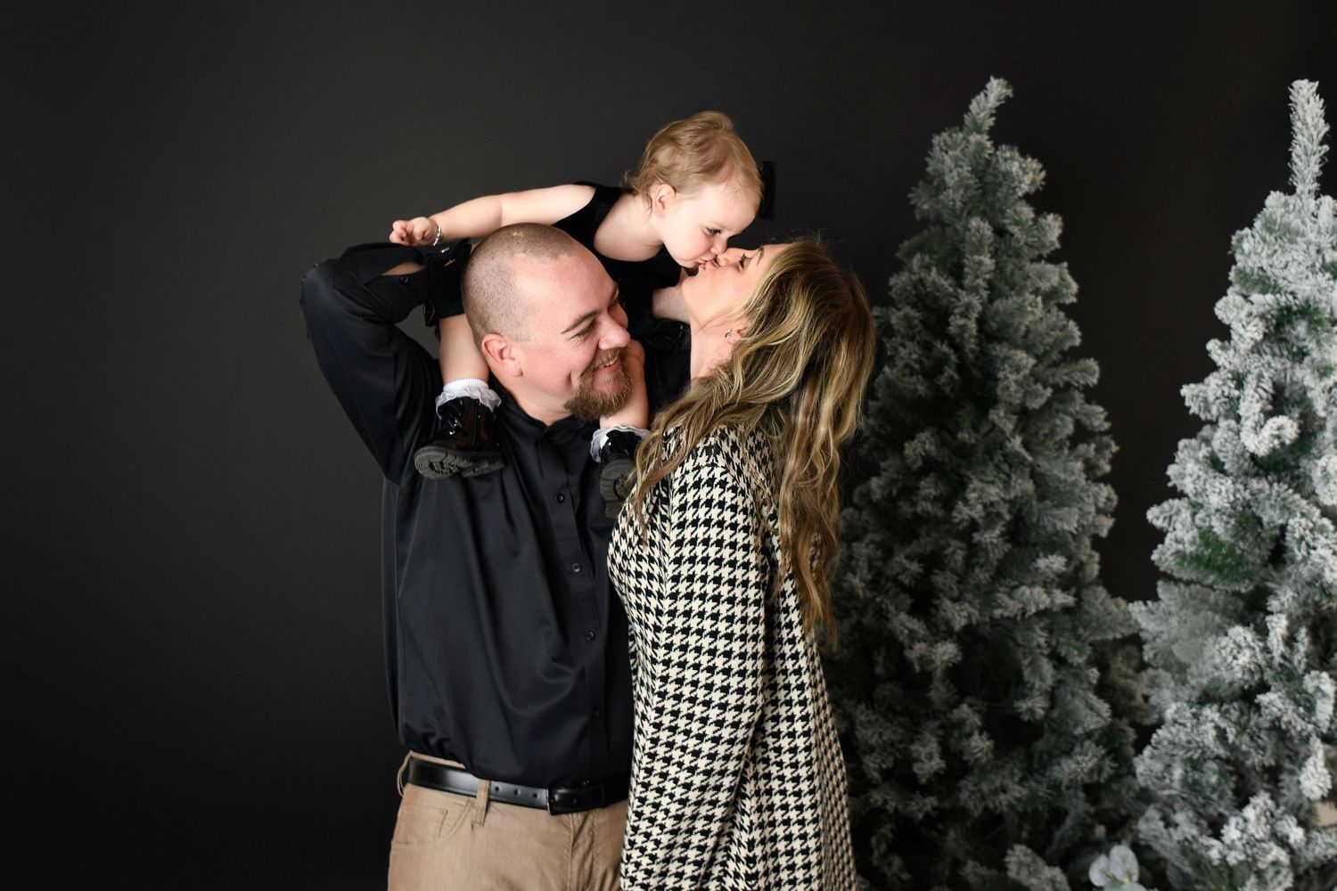 Christmas mini Session of family kissing in luxury black fancy studio Christmas Mini session Christmas Card Photos