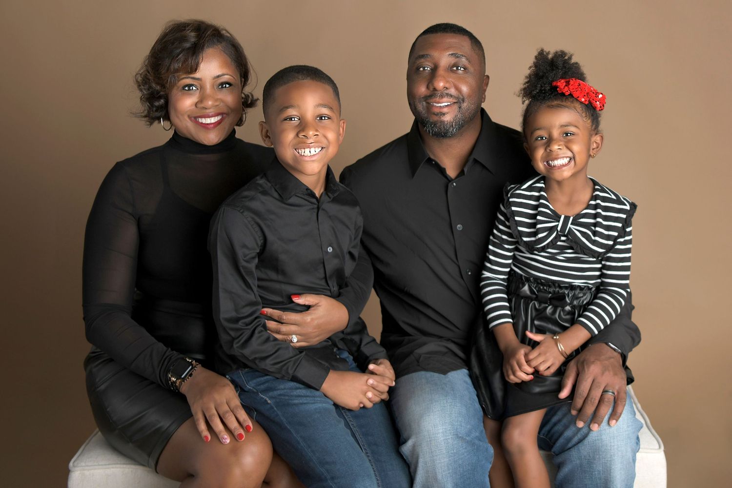 Family portrait with a soft, blurred background in the studio.