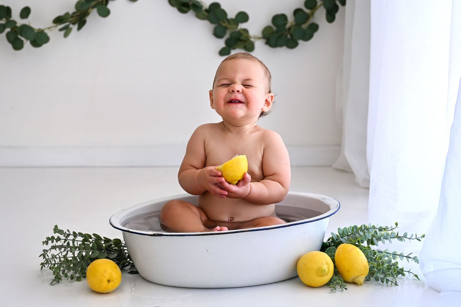 Adorable baby boy surrounded by eucalyptus and lemon bath in natural light Phoenix Studio