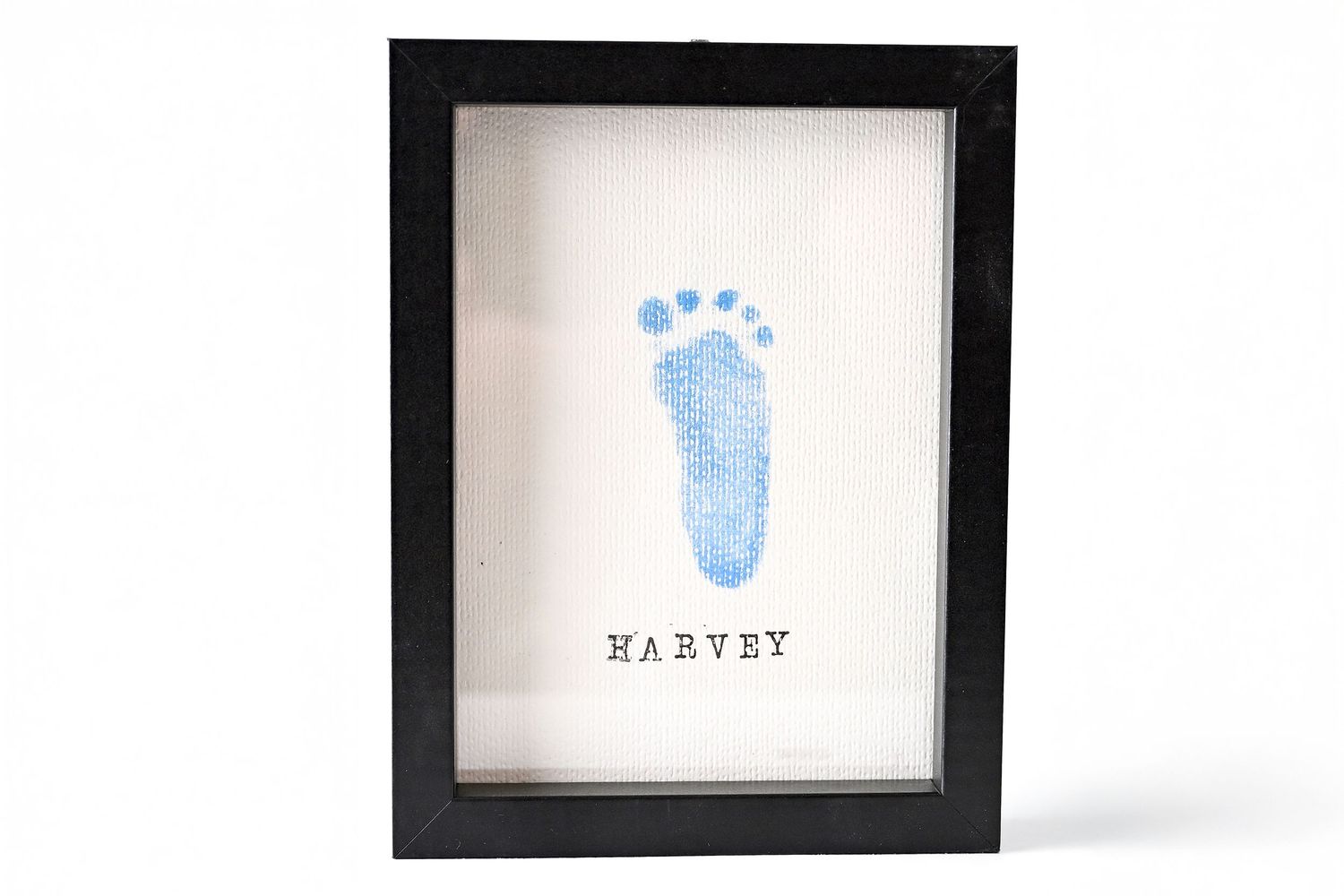 A framed handmade keepsake of a baby girls newborn footprint