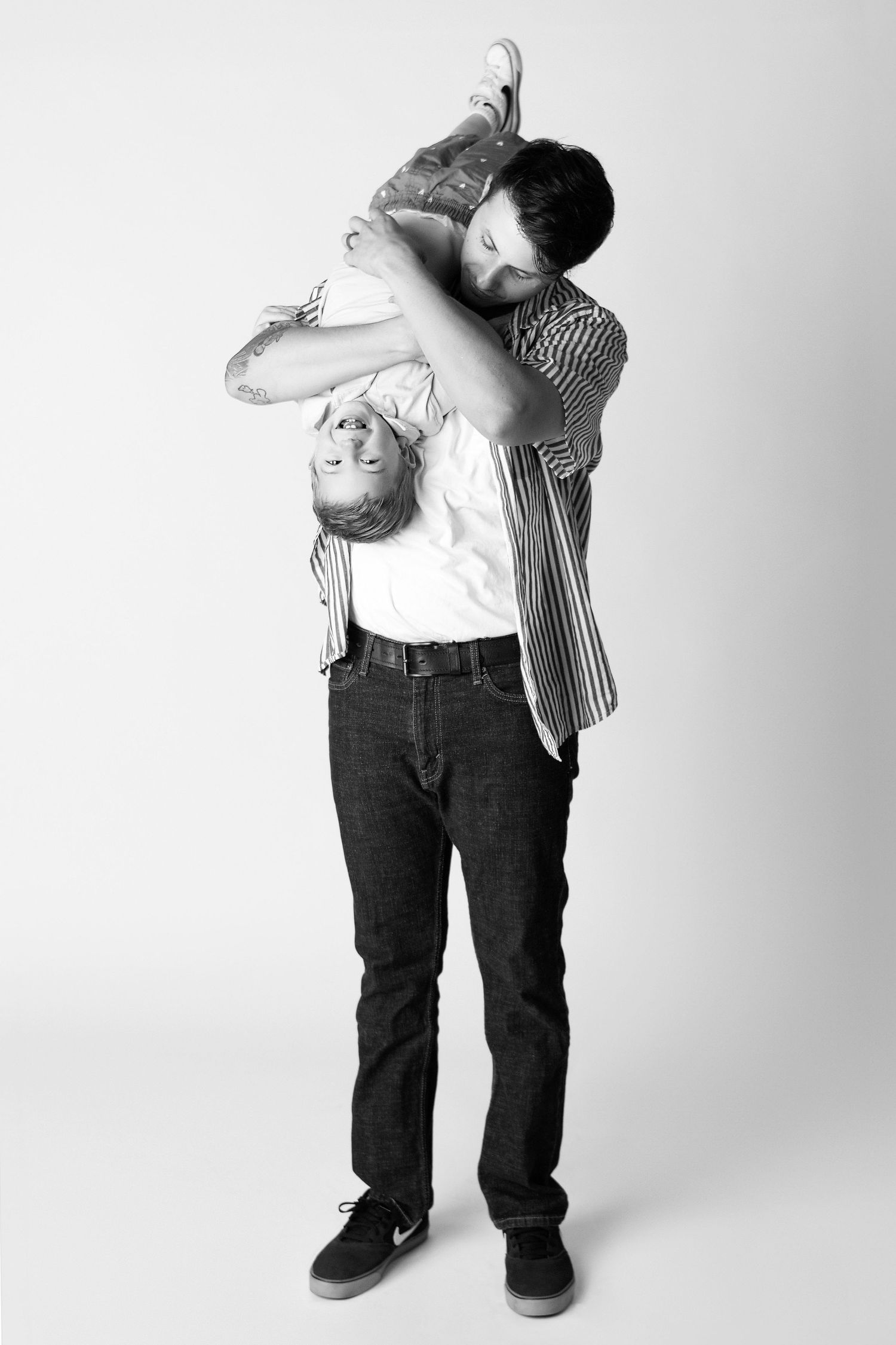 Father holding son upside down for Father's Day phoenix studio mini session