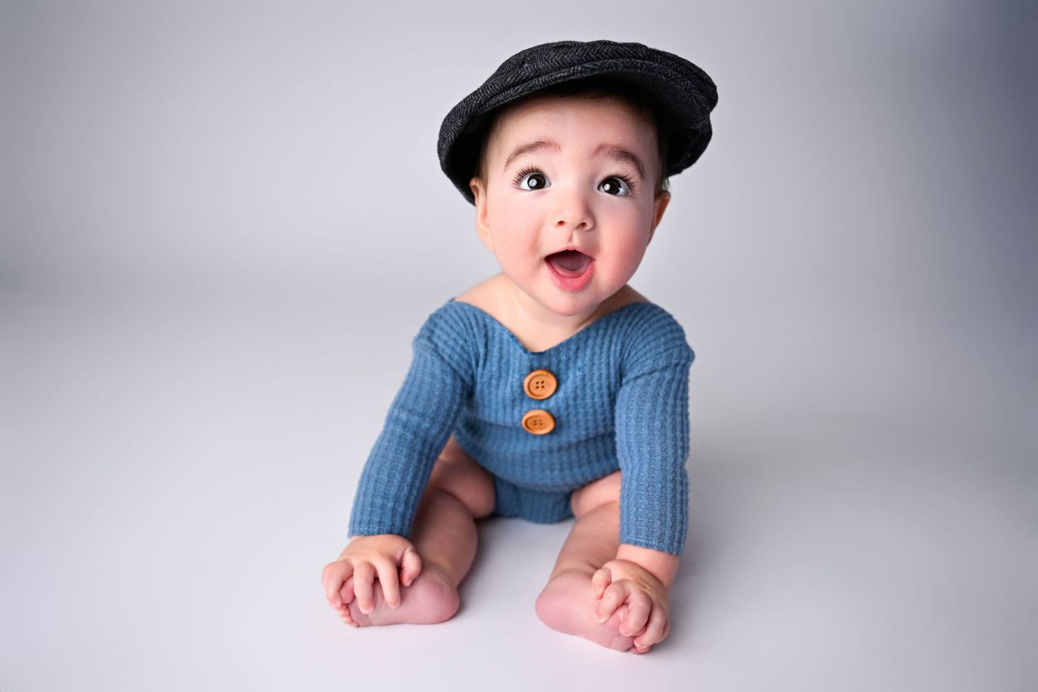Baby boy sits up for milestone photography session in studio