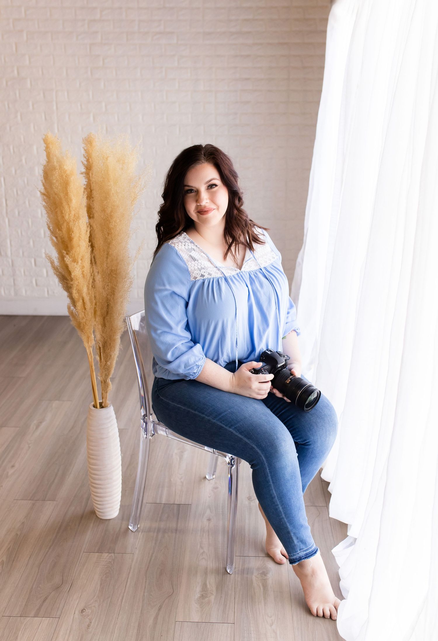 Professional headshot of a woman holding a camera in tempe arizona