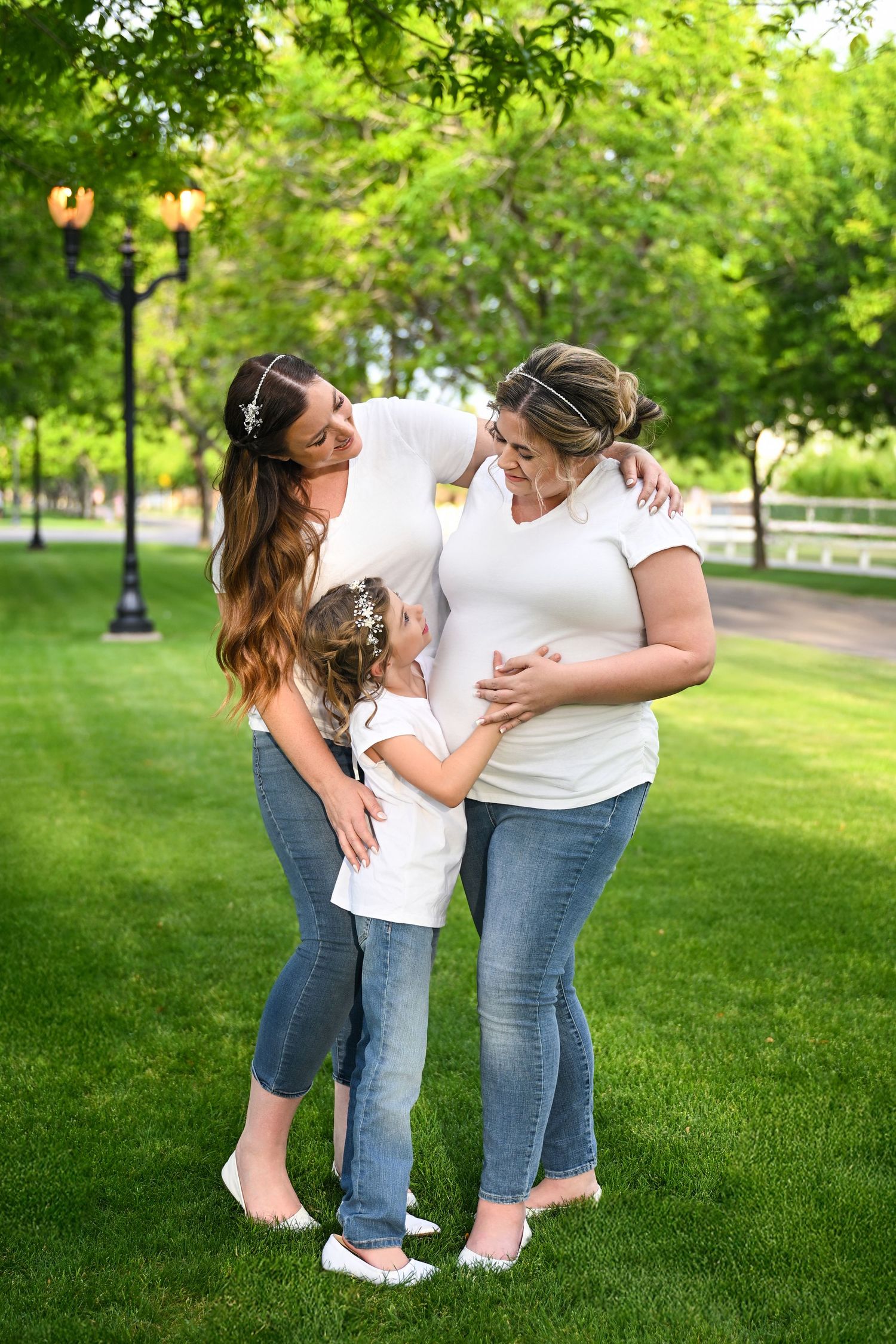 Candid family moment with partner and children next to a pregnant mother.