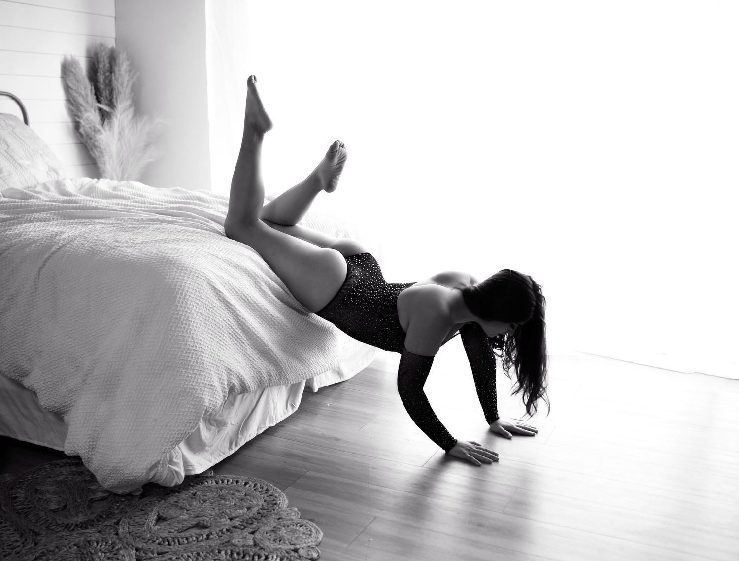 Advanced posing sexy back lit black and white image of boudoir posing
