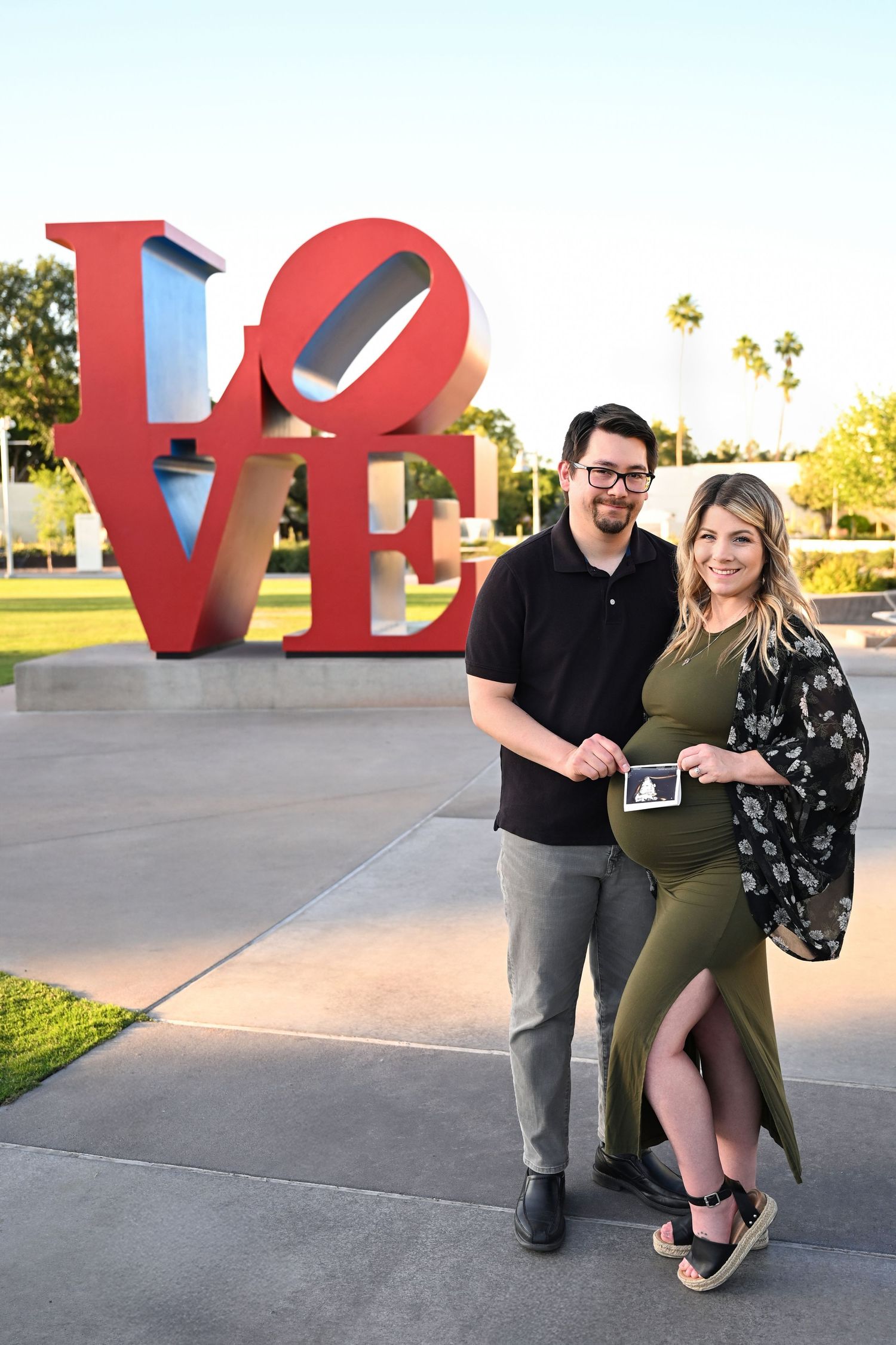 Thoughtful pose of expectant mother and spouse in an arizona downtown location.